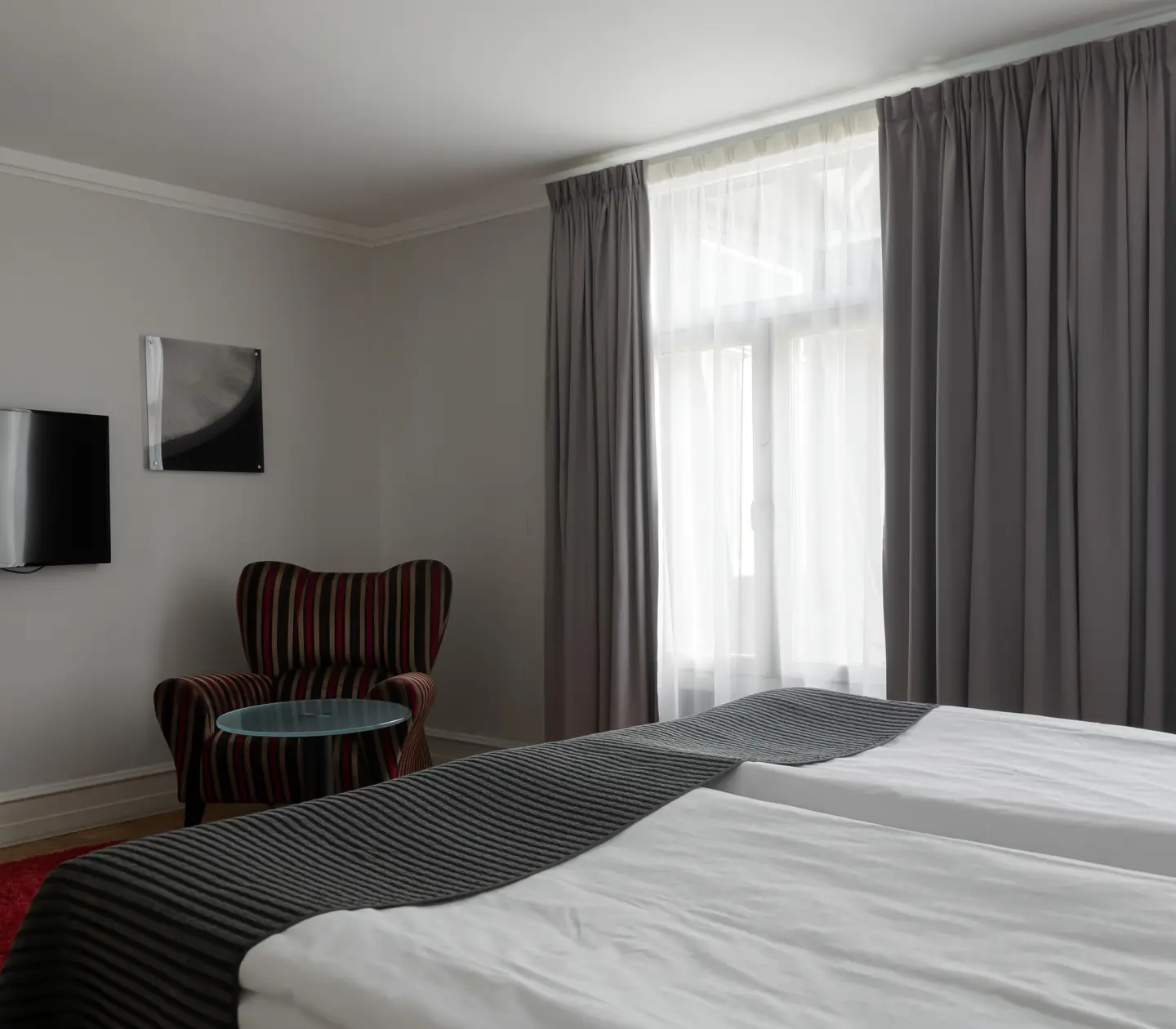 Hotel room with double bed, window and TV