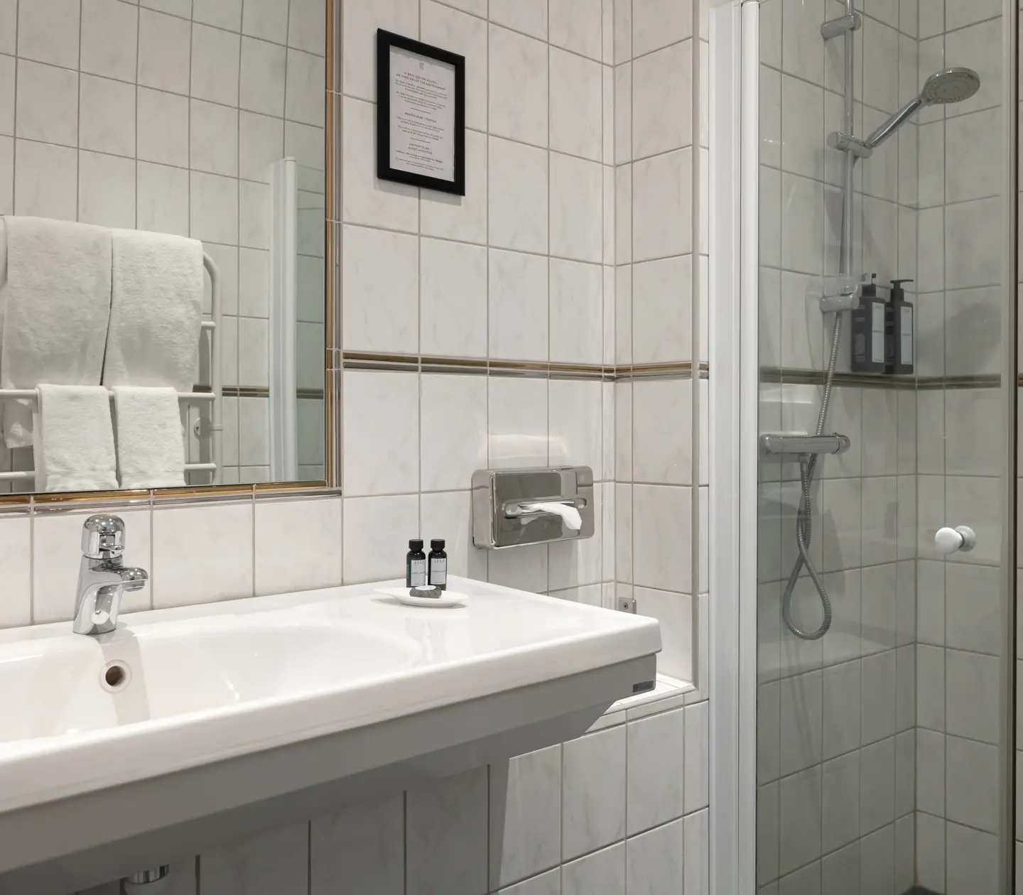 White tiles with sink, mirror and shower