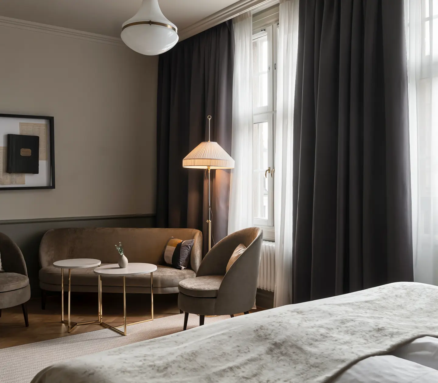 Cozy hotel room with sofa group, floor lamp and curtains