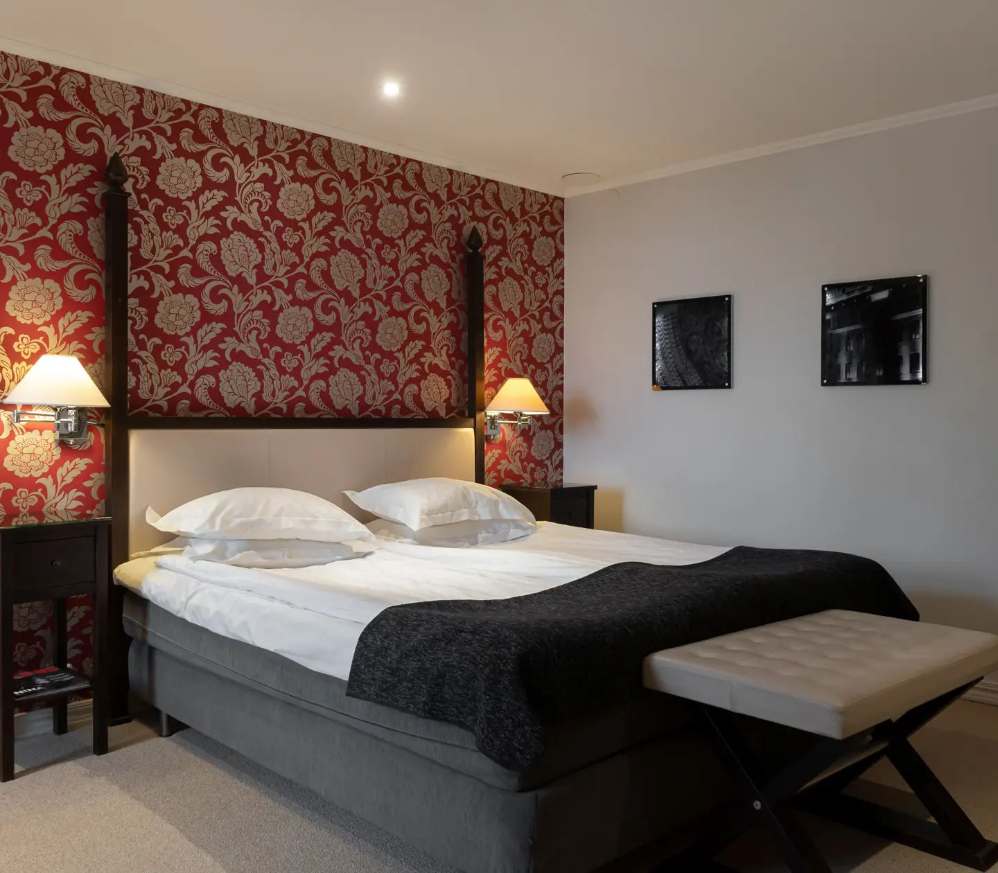 Hotel room with double bed, end wall and lamps