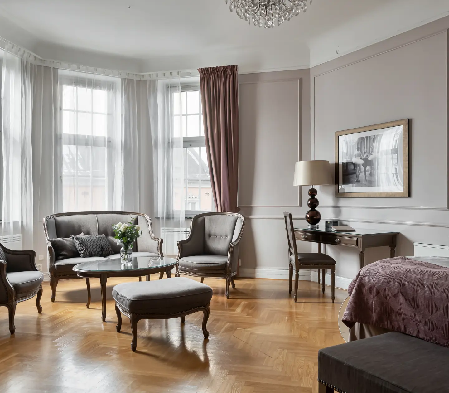 Hotel room with sofa group, desk and window