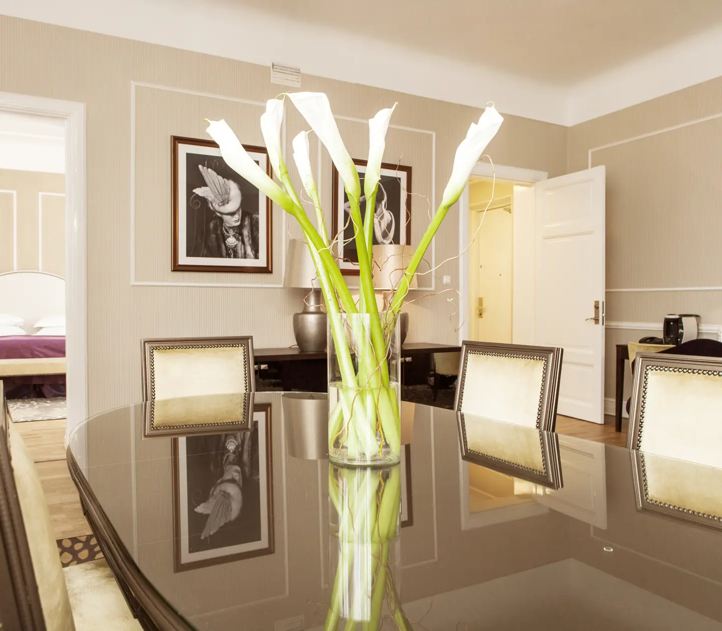 Suite with dining table, bouquet and double bed