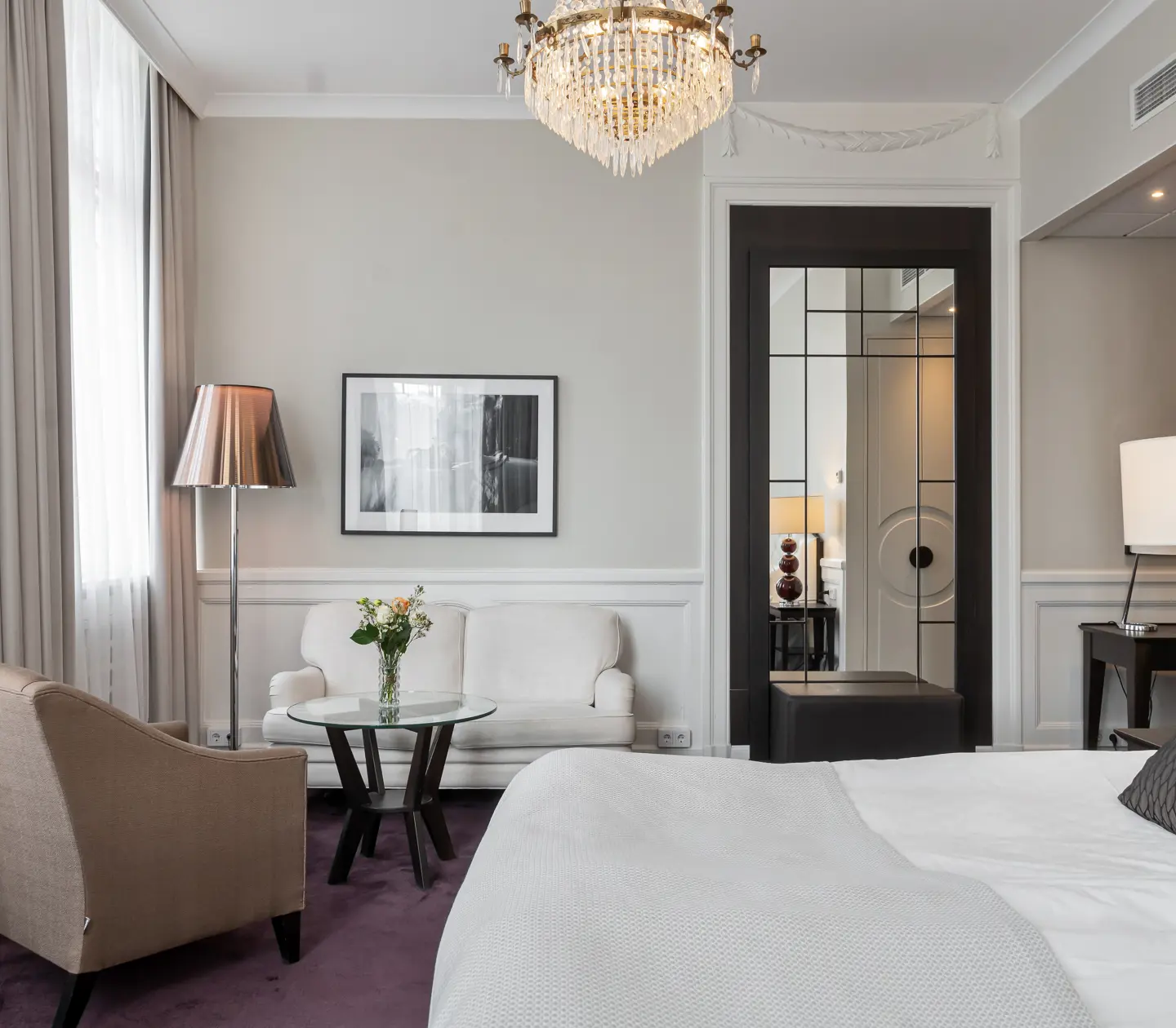 Suite with double bed, sofa group and mirror
