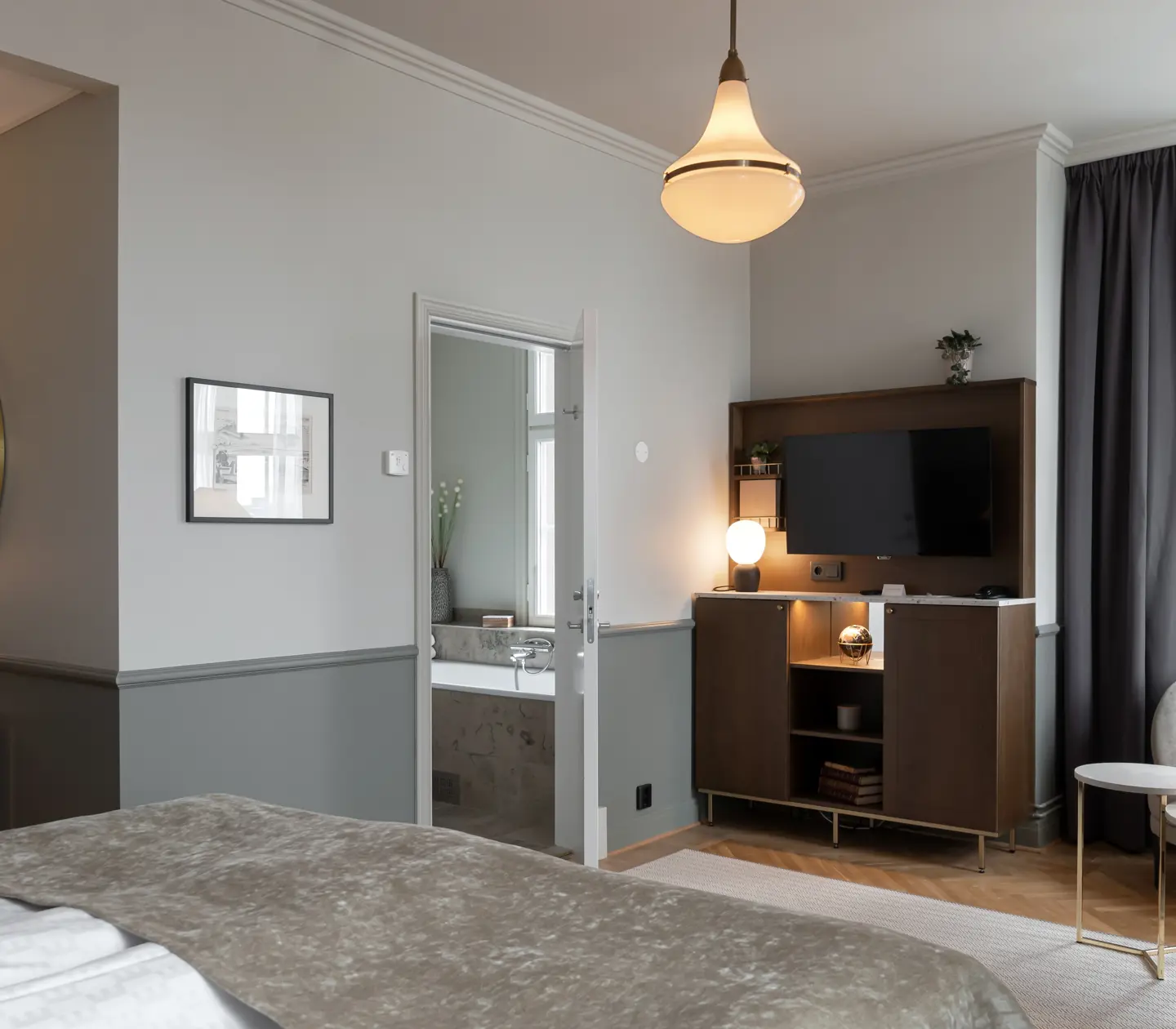 Suite with sofa group, TV and door to bathroom