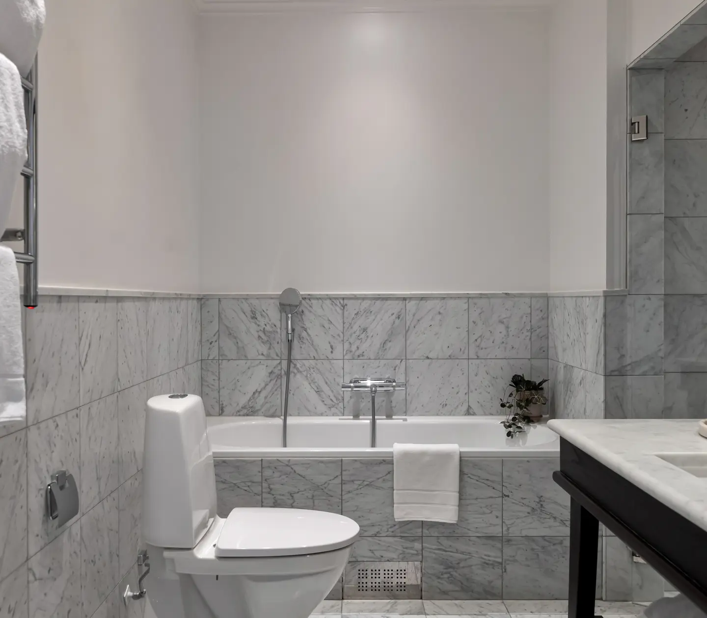 Bright bathroom with bathtub, toilet and sink