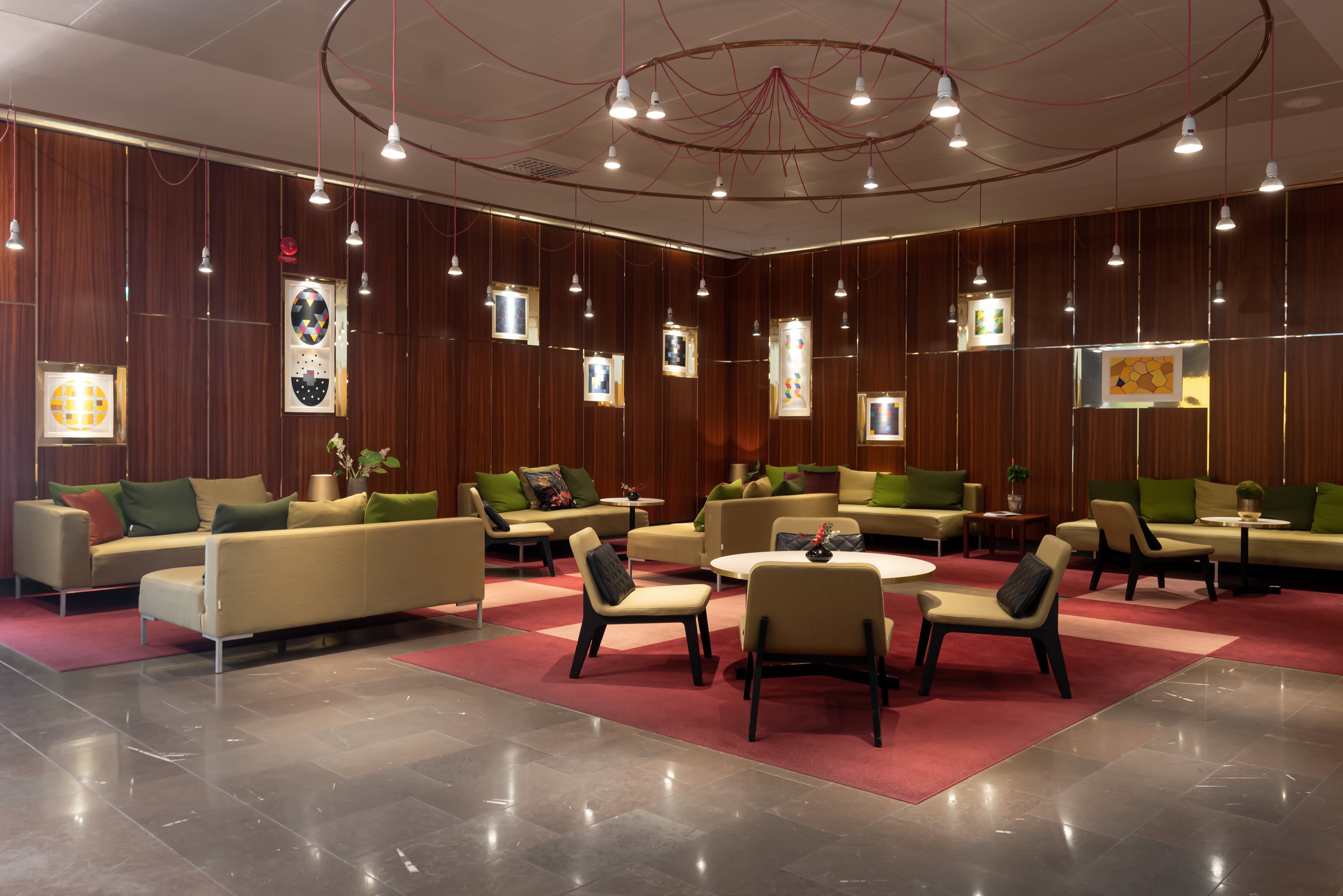 Hotel lobby with lounge furniture and large ceiling lamp
