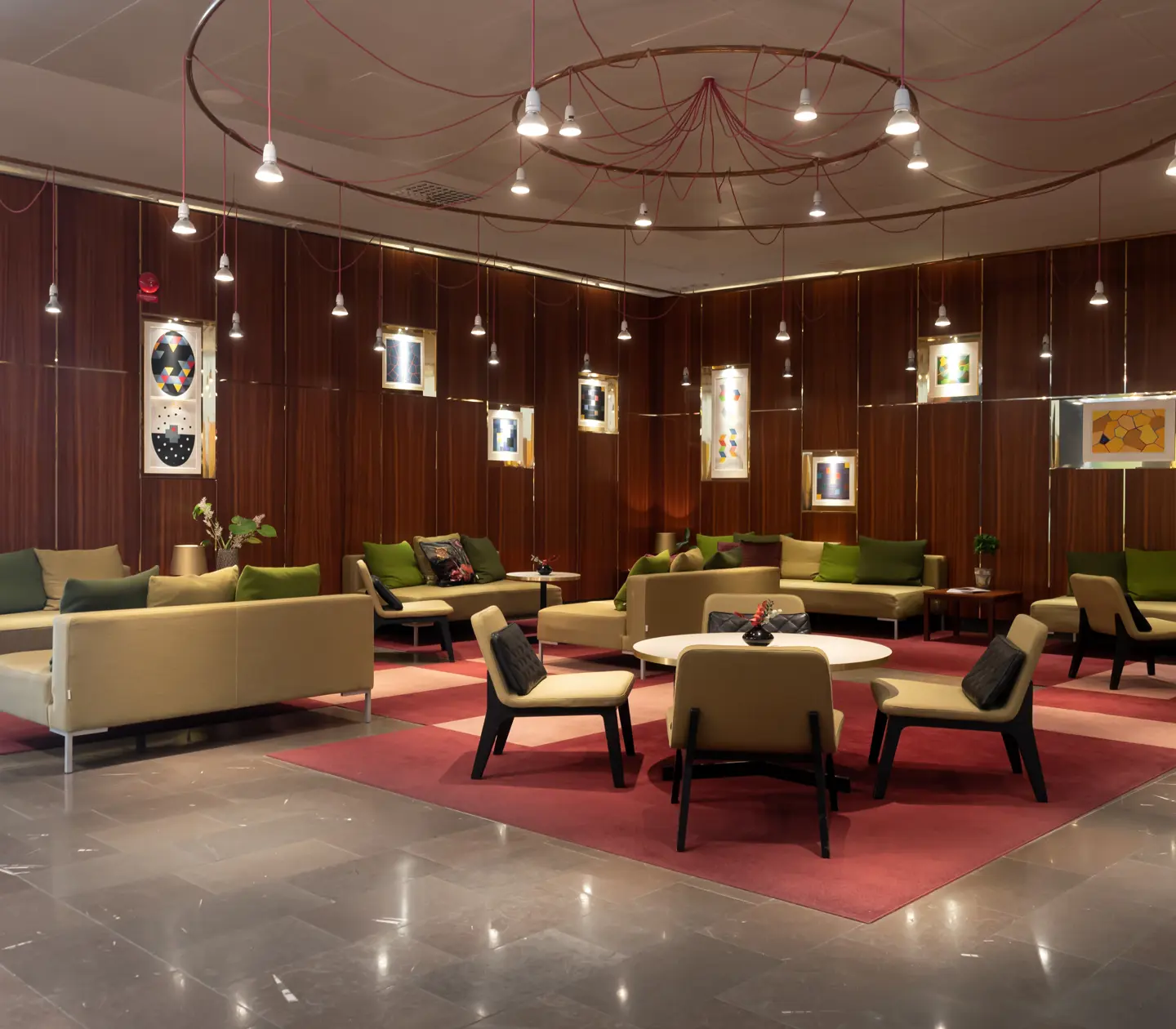 Hotel lobby with lounge furniture and large ceiling lamp