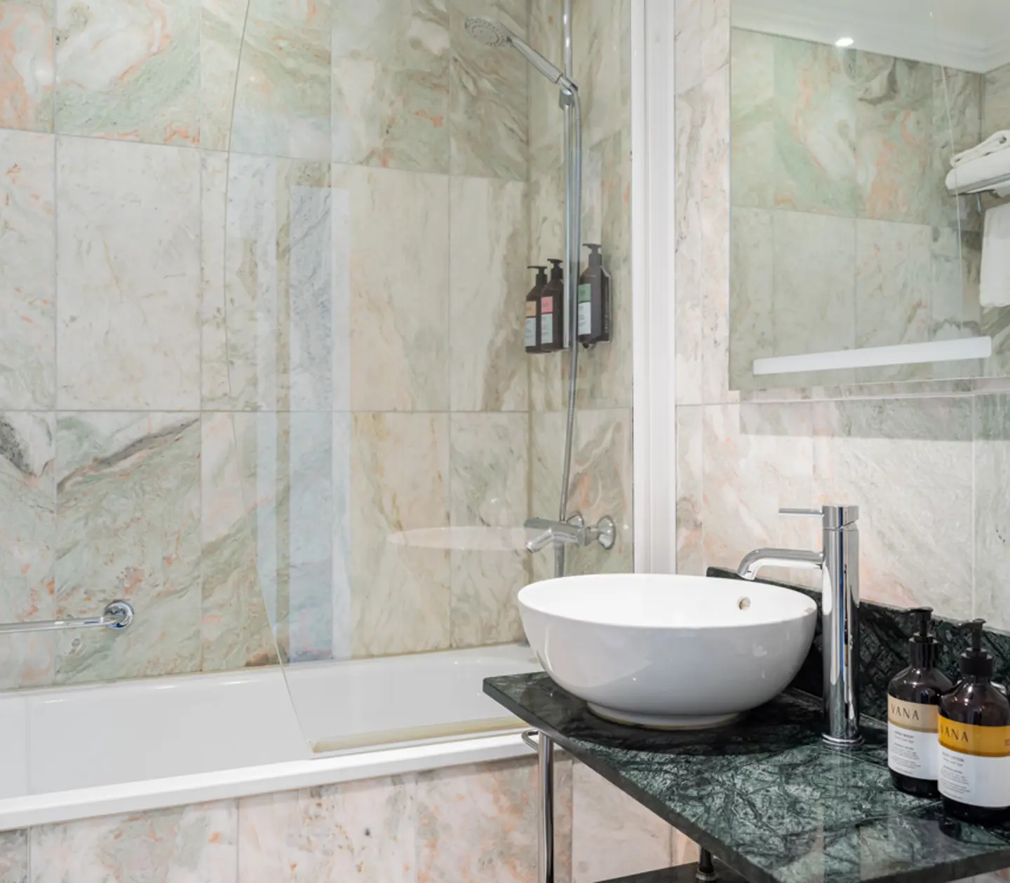 Bright bathroom with sink, mirror and shower