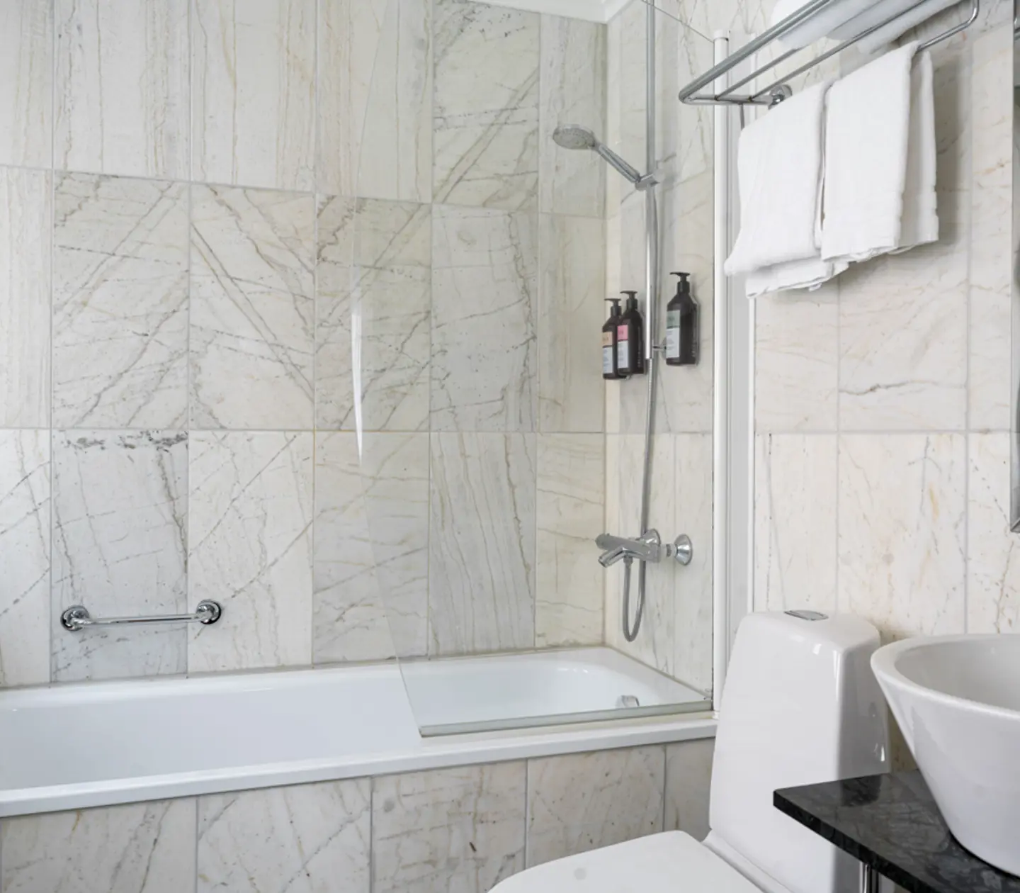 Bright bathroom with sink, mirror and shower