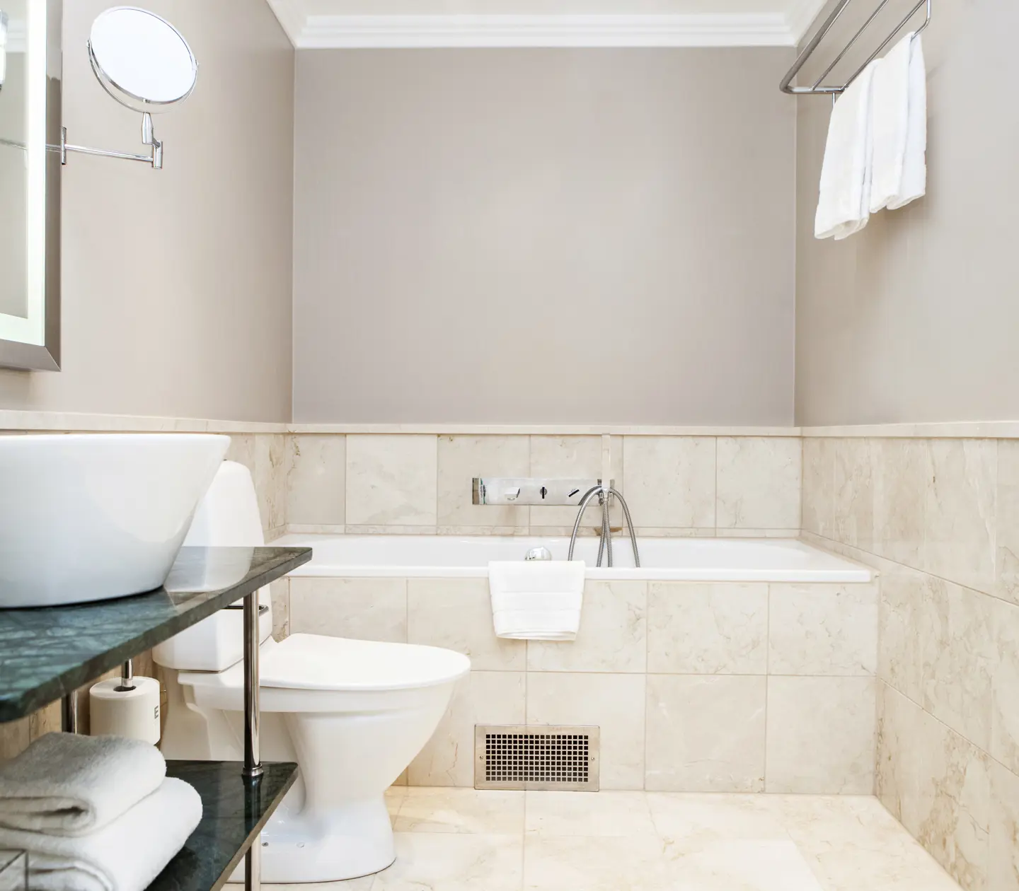 Beige bathroom with bathtub, sink and toilet