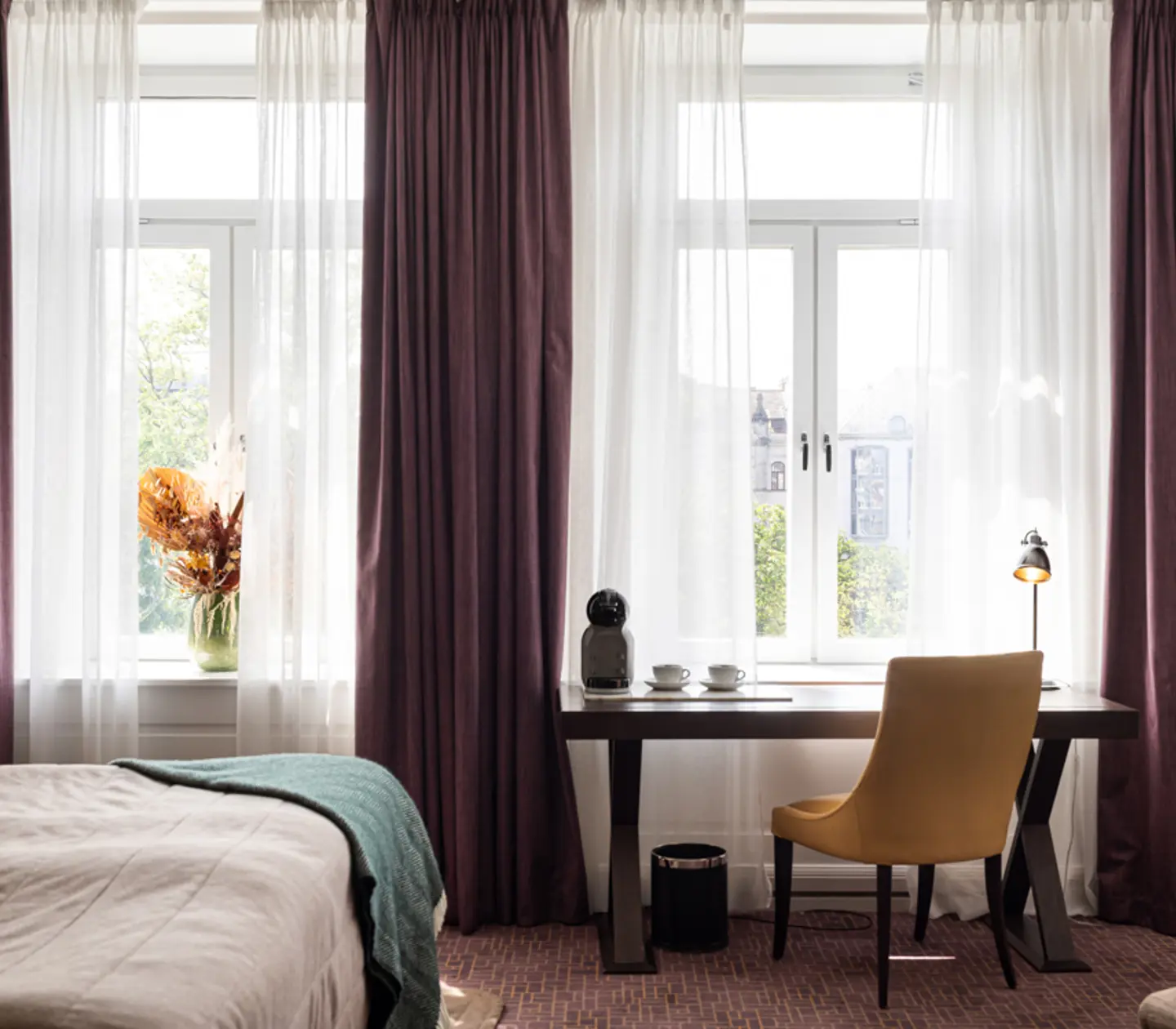 Cozy suite with bed, armchair and desk