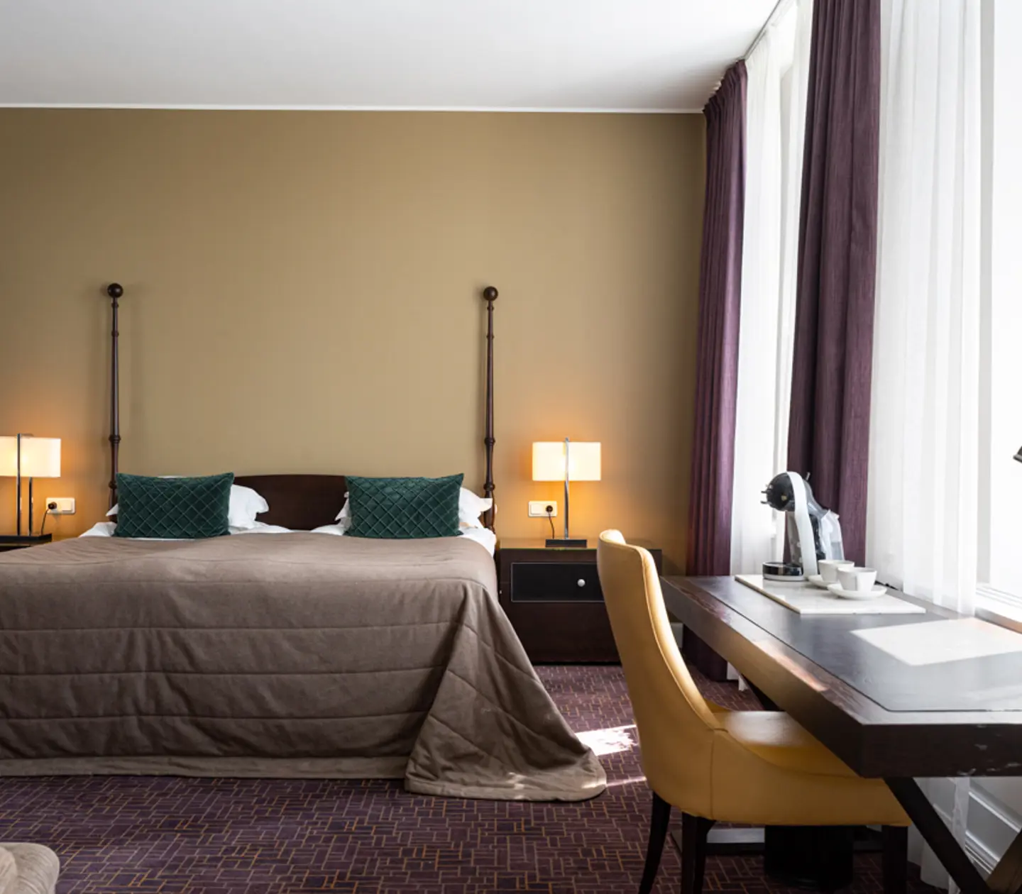 Cozy suite with sofa group, window and painting