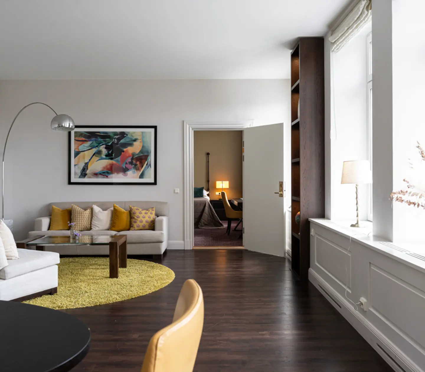 Cozy suite with bed, armchairs and window