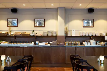Breakfast buffet served on a table along the wall