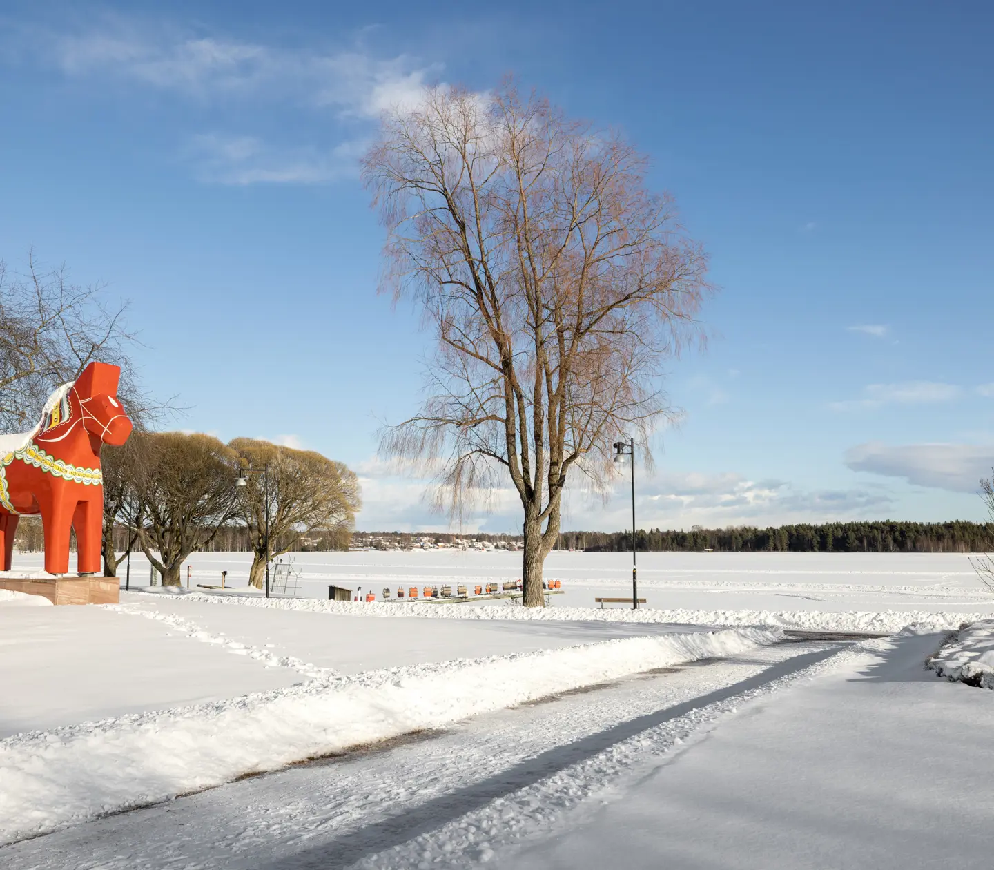 Central Mora covered in snow with a large Dala horse and a view of Siljan