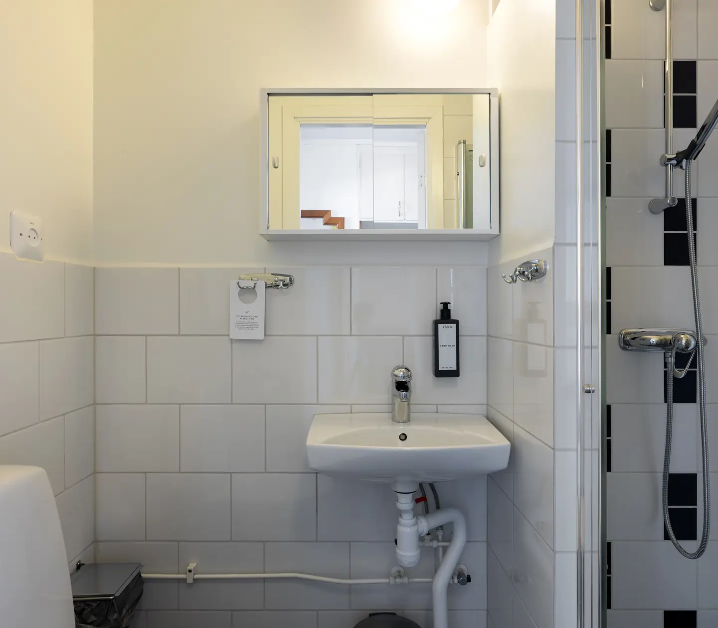 Bright bathroom with toilet, sink and shower