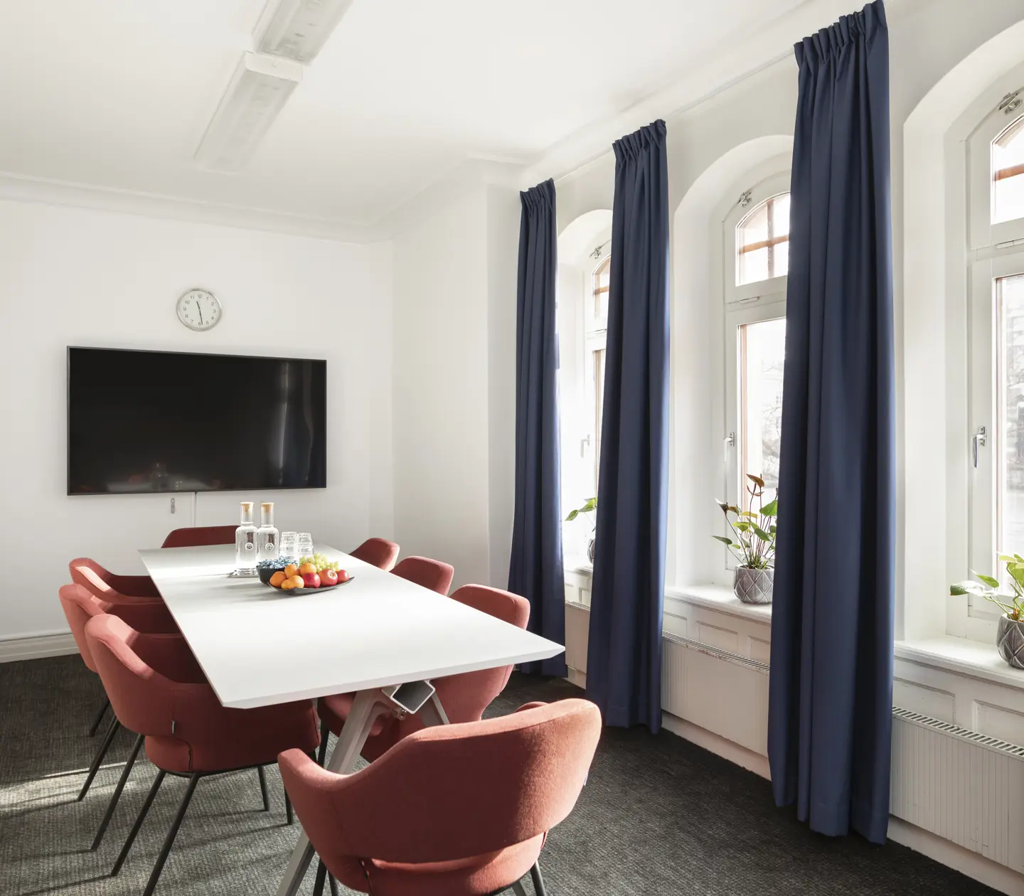 Conference room with red chairs, TV and window