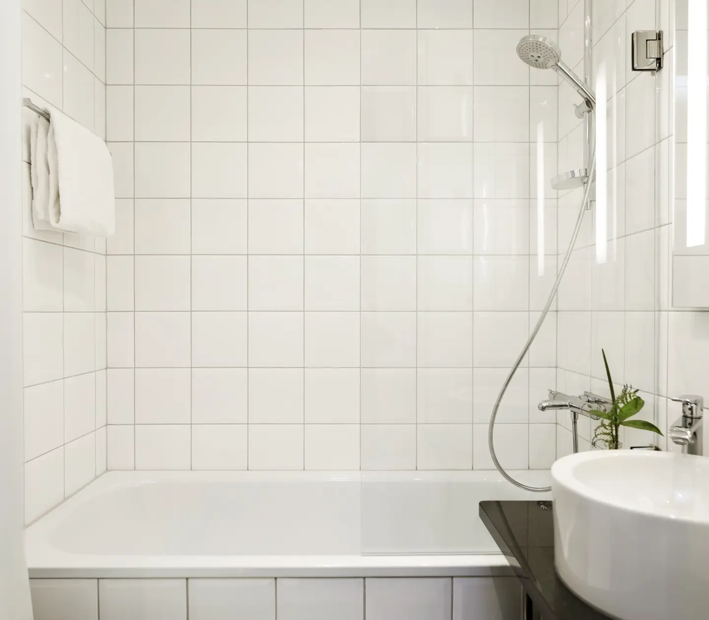 Bright bathroom with sink, mirror and bathtub