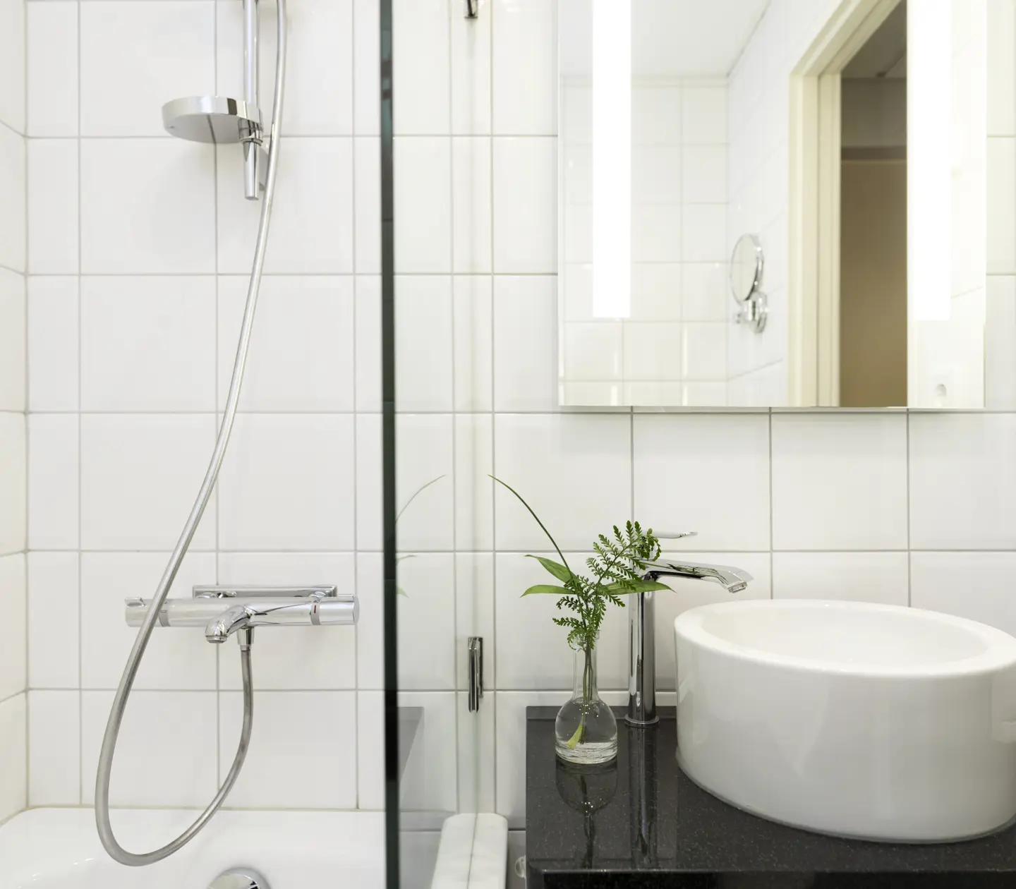 Bright bathroom with sink, mirror and shower