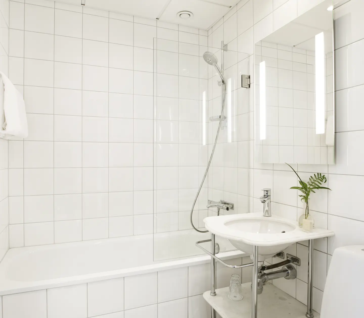 Bright bathroom with sink, mirror and bathtub