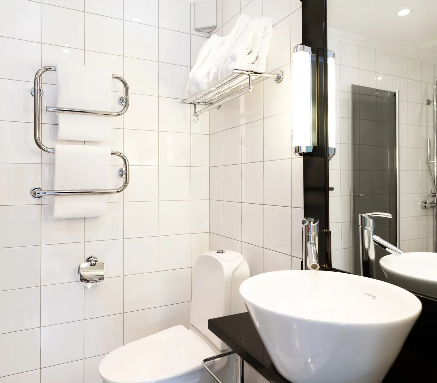 Bright bathroom with shower, sink and toilet