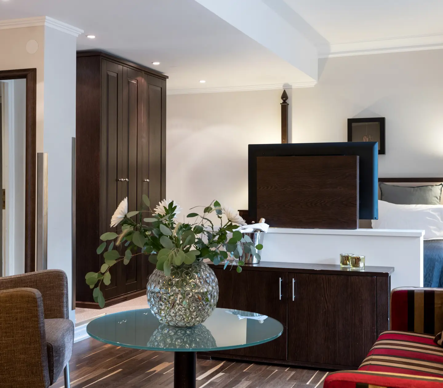 Hotel room with sofa group, bouquet and wardrobe