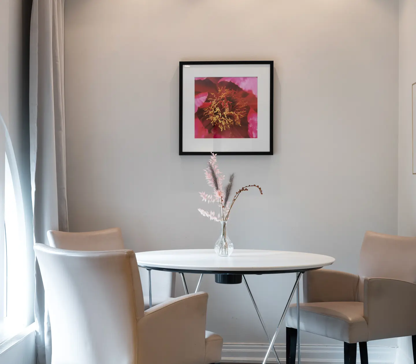 Hotel room with dining area, paintings and windows