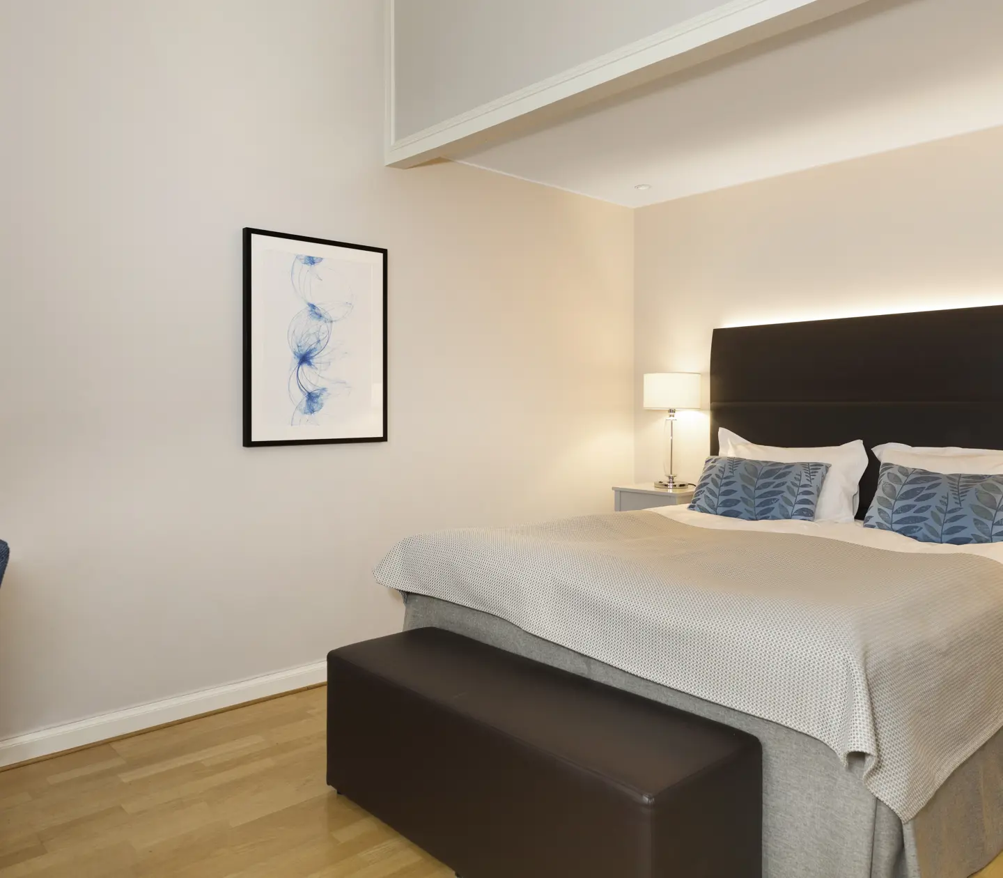 Bright hotel room with bed, desk and blackboard