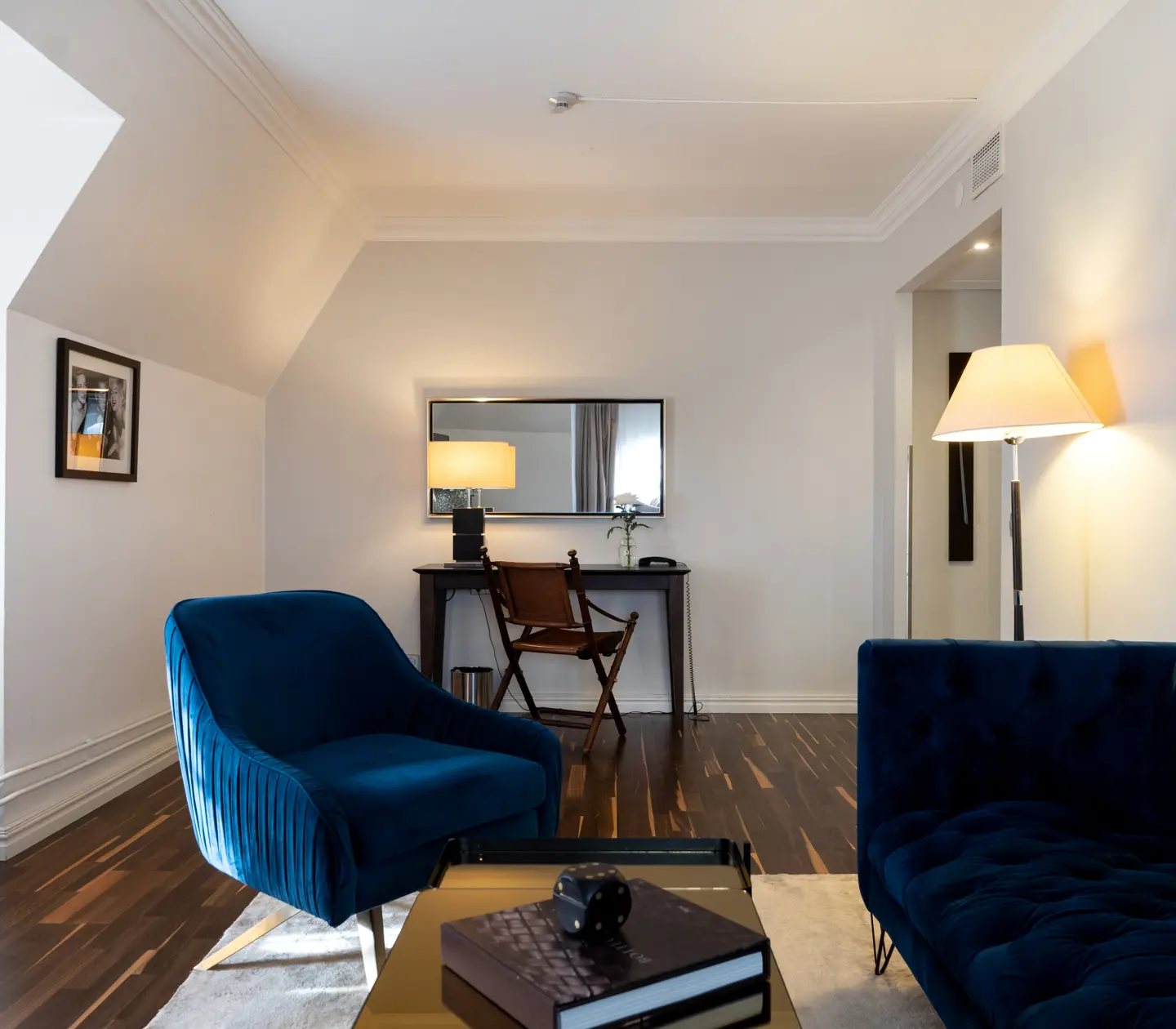 Cozy suite with sofa group, desk and mirror