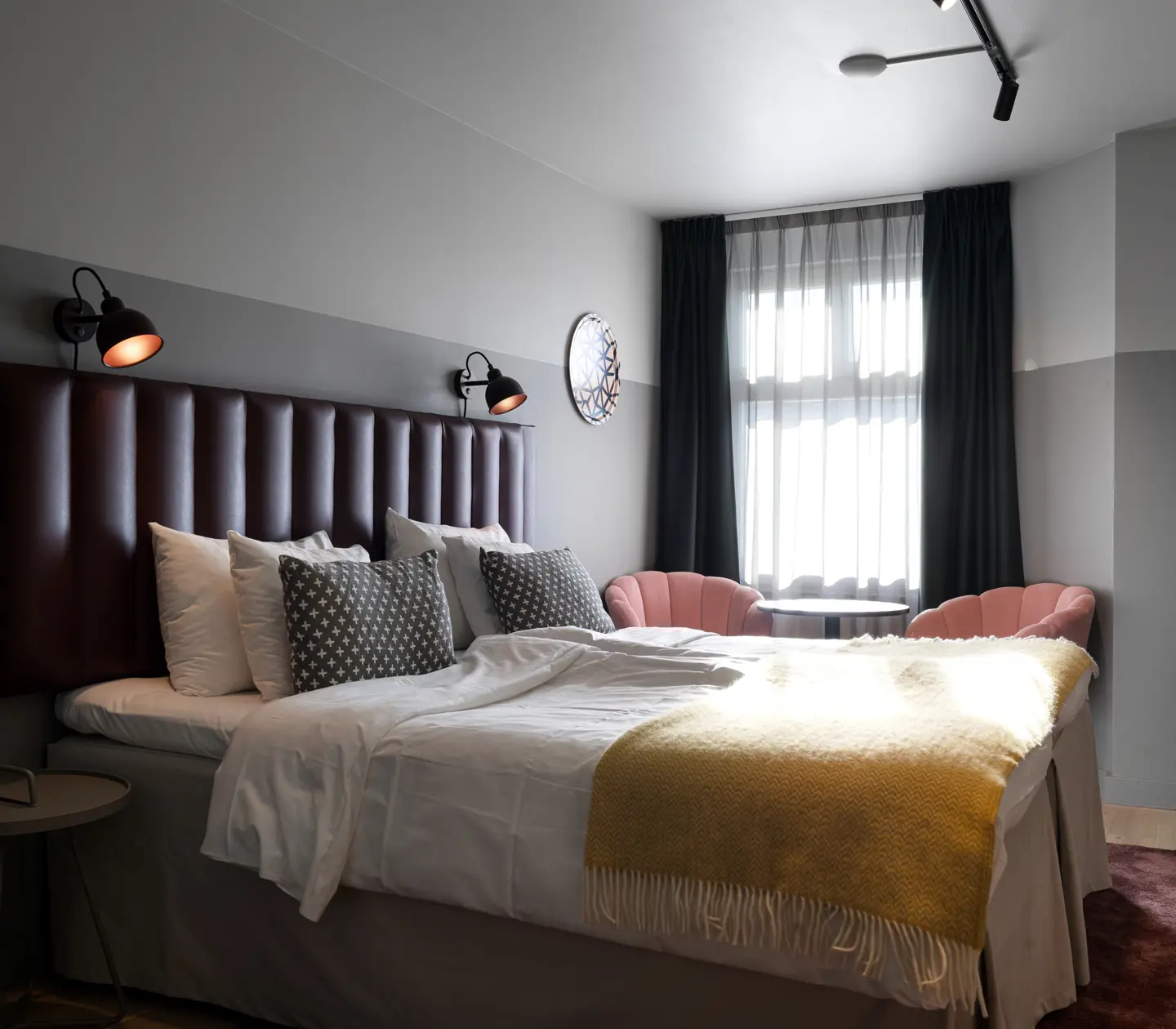 Hotel room with double bed, armchairs and window