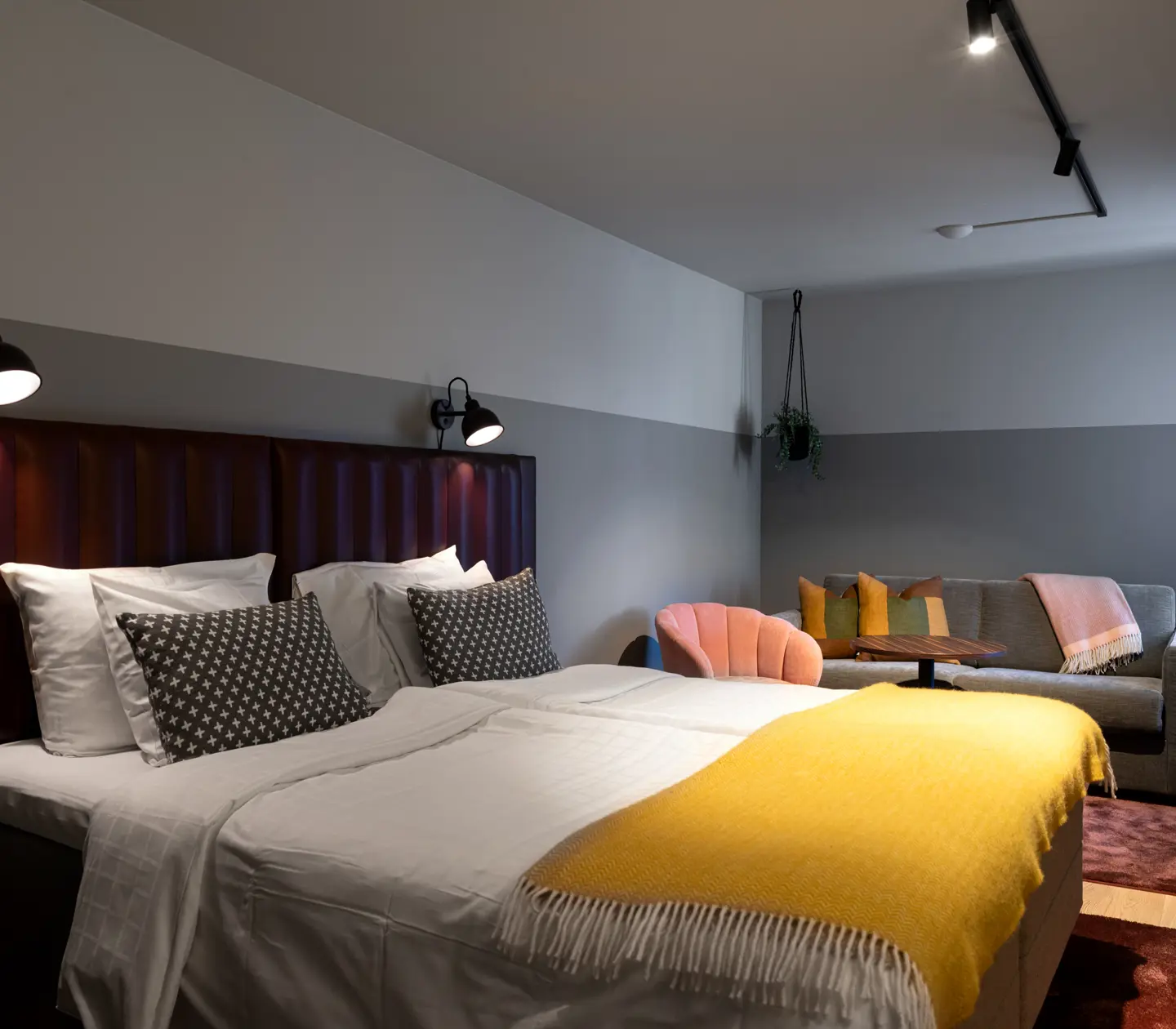 Cozy hotel room with double bed and sofa group