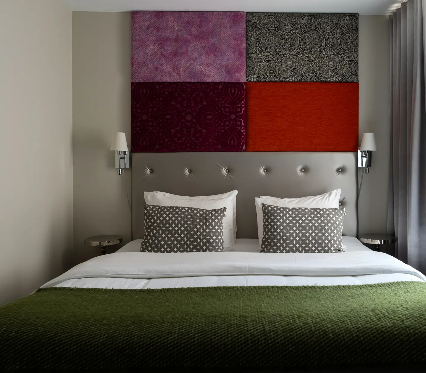 Hotel room with double bed and colorful headboard