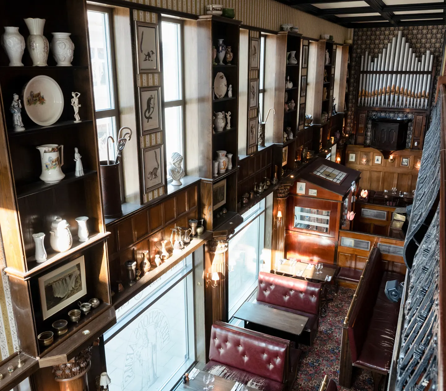 Pub environment with high ceilings, seating and lots of decorations