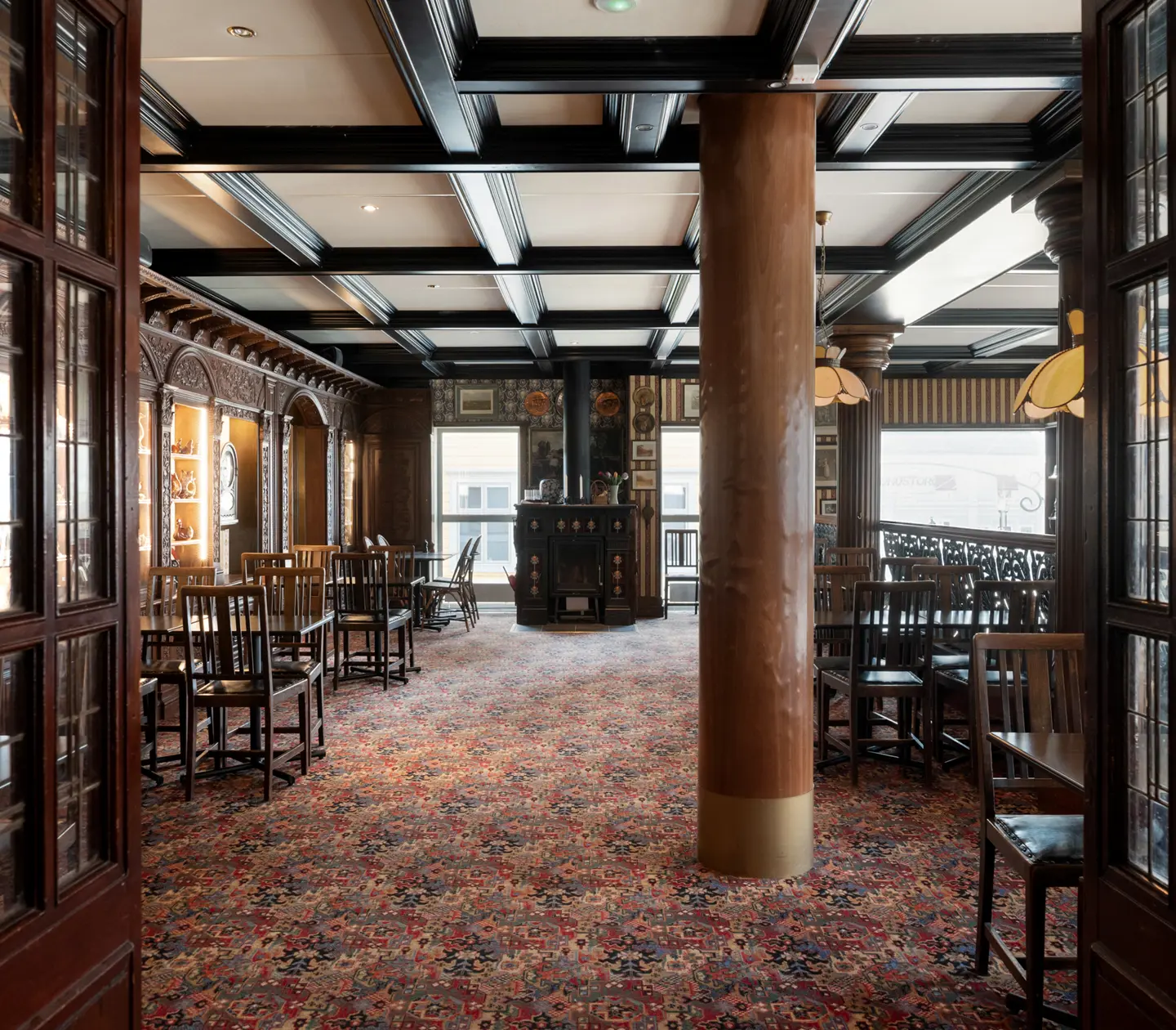 Pub environment with seating, wooden beams in the ceiling and ceiling lights