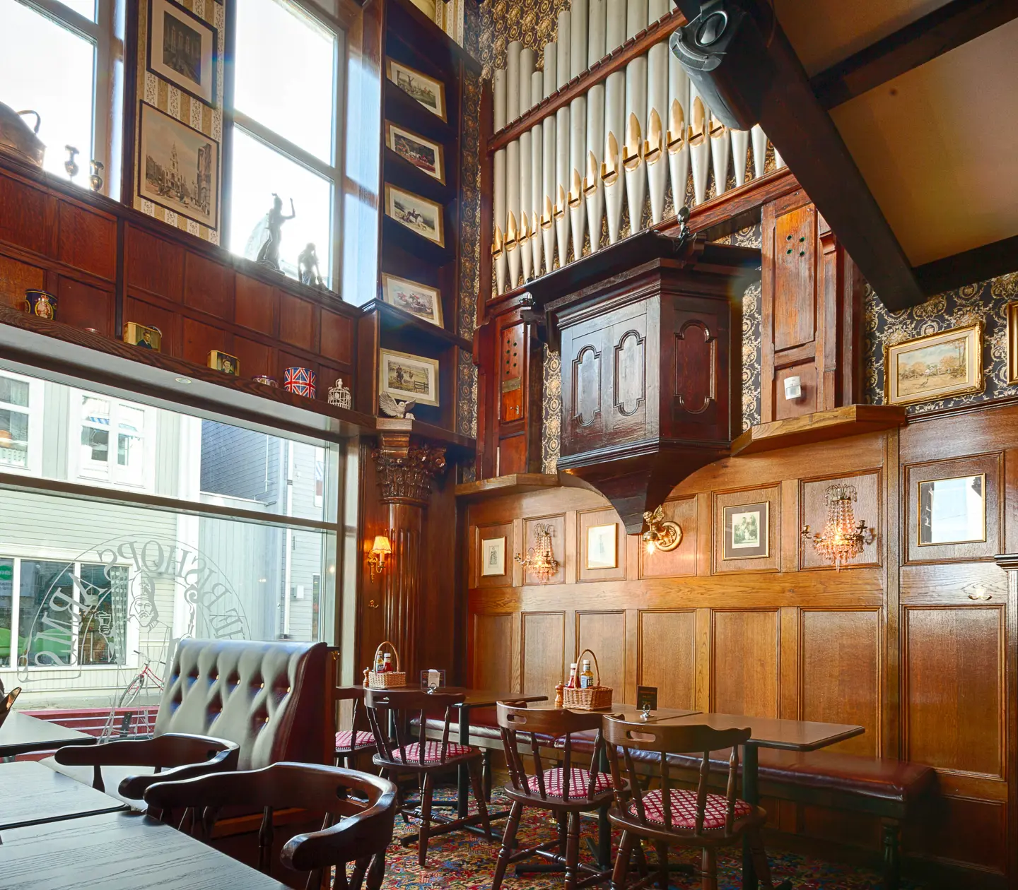 Pub environment with high ceilings, seating and lots of decorations