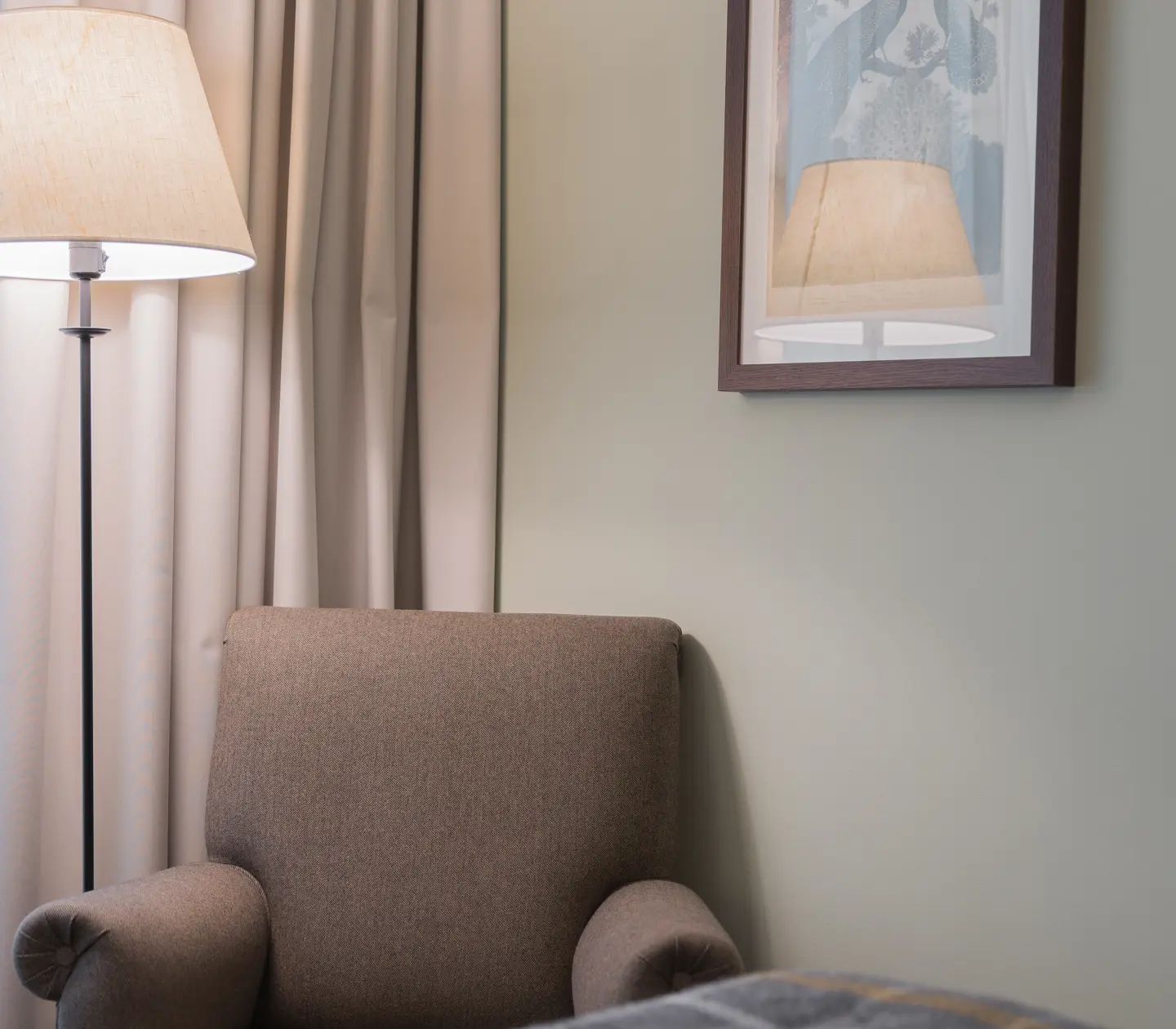 Hotel room with armchair, floor lamp and blackboard