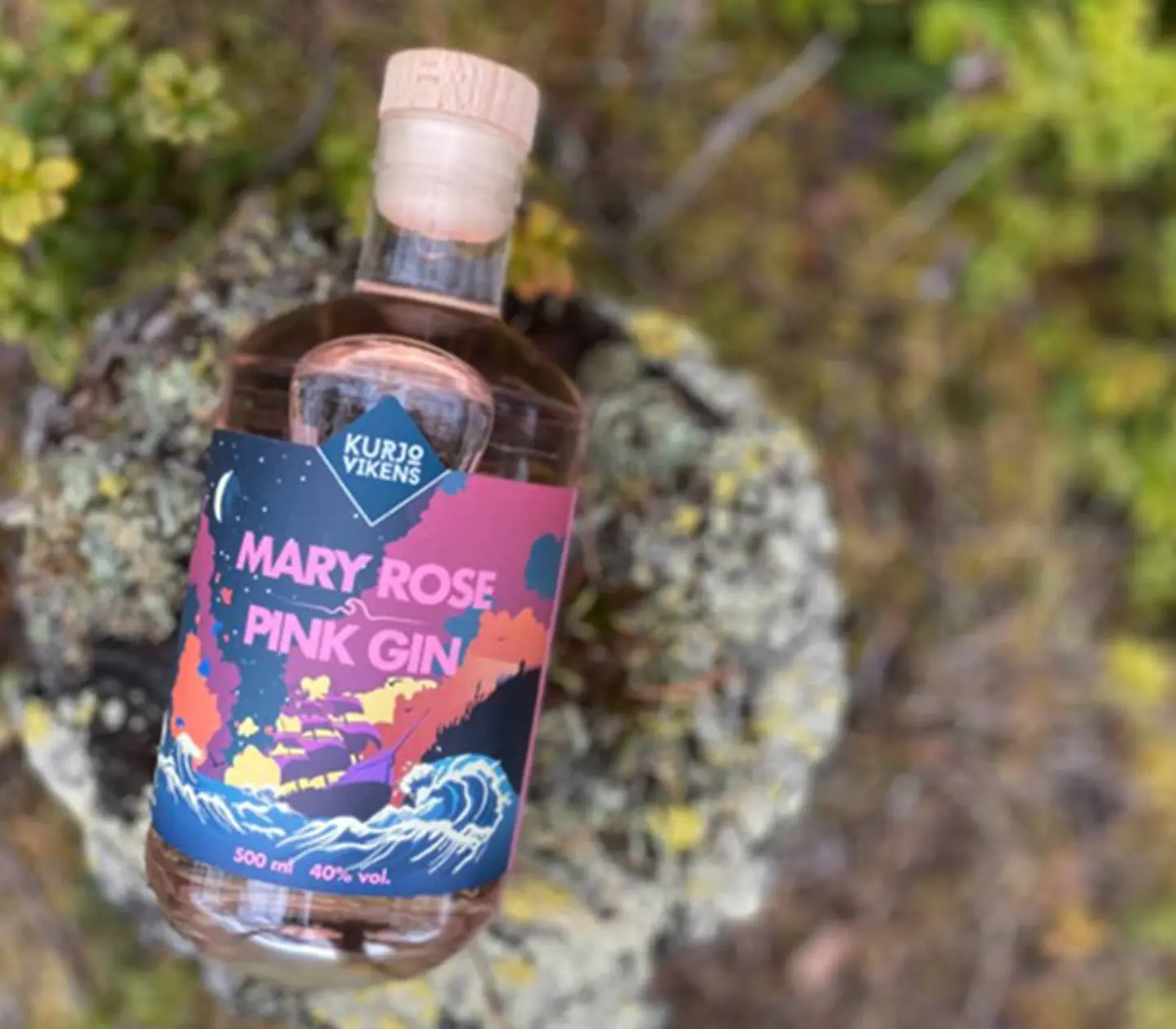 Colorful gin bottle in nature