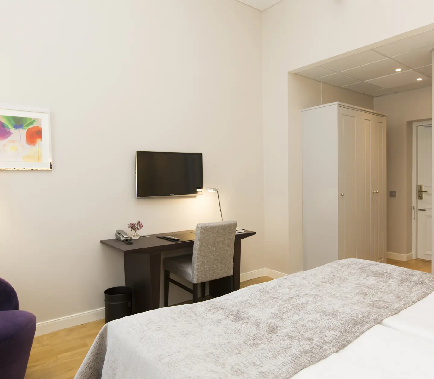 Double bed with armchair and desk