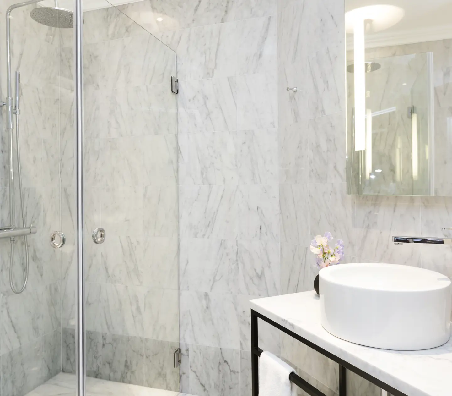 Marble bathroom with shower and sink