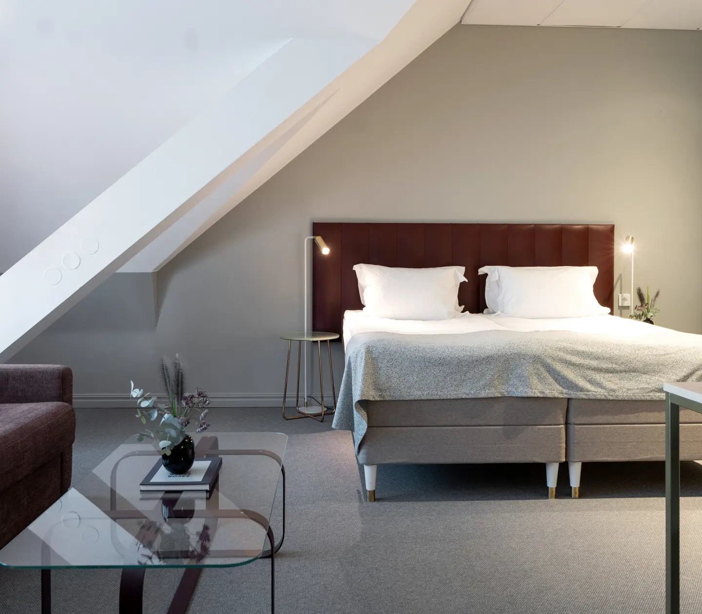 Room with slanted ceiling, double bed and sofa