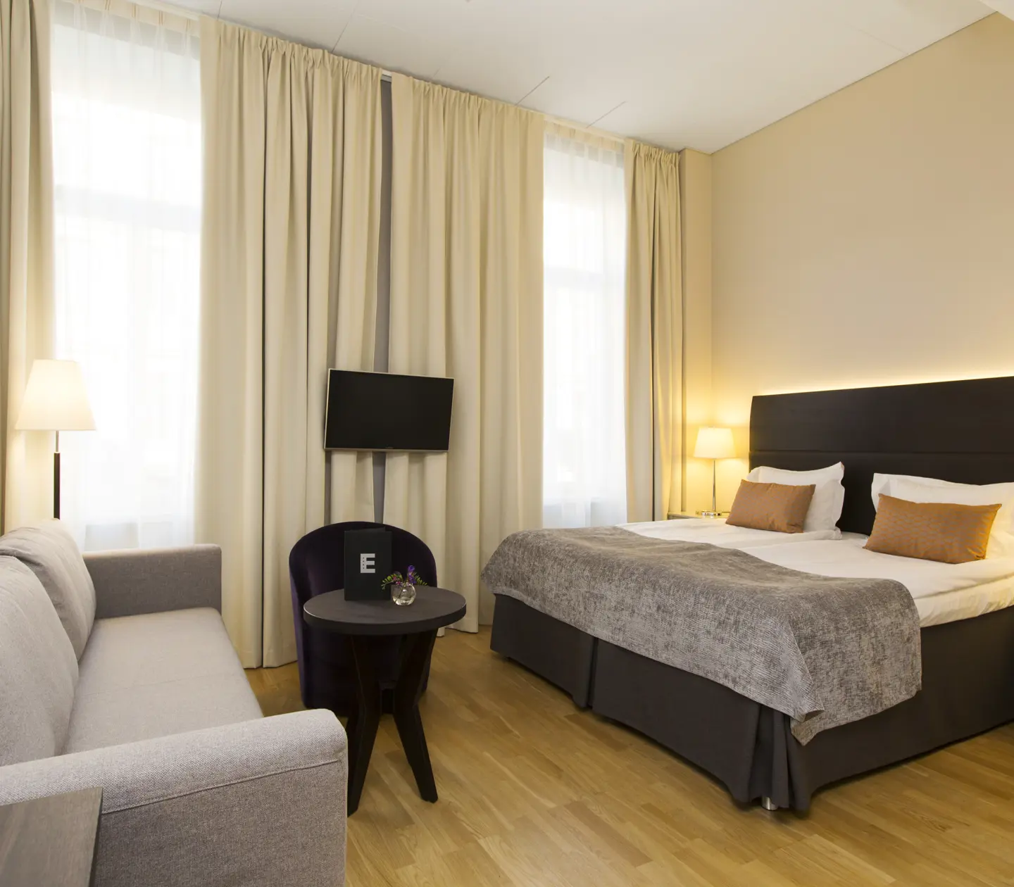 Room with double bed and sofa