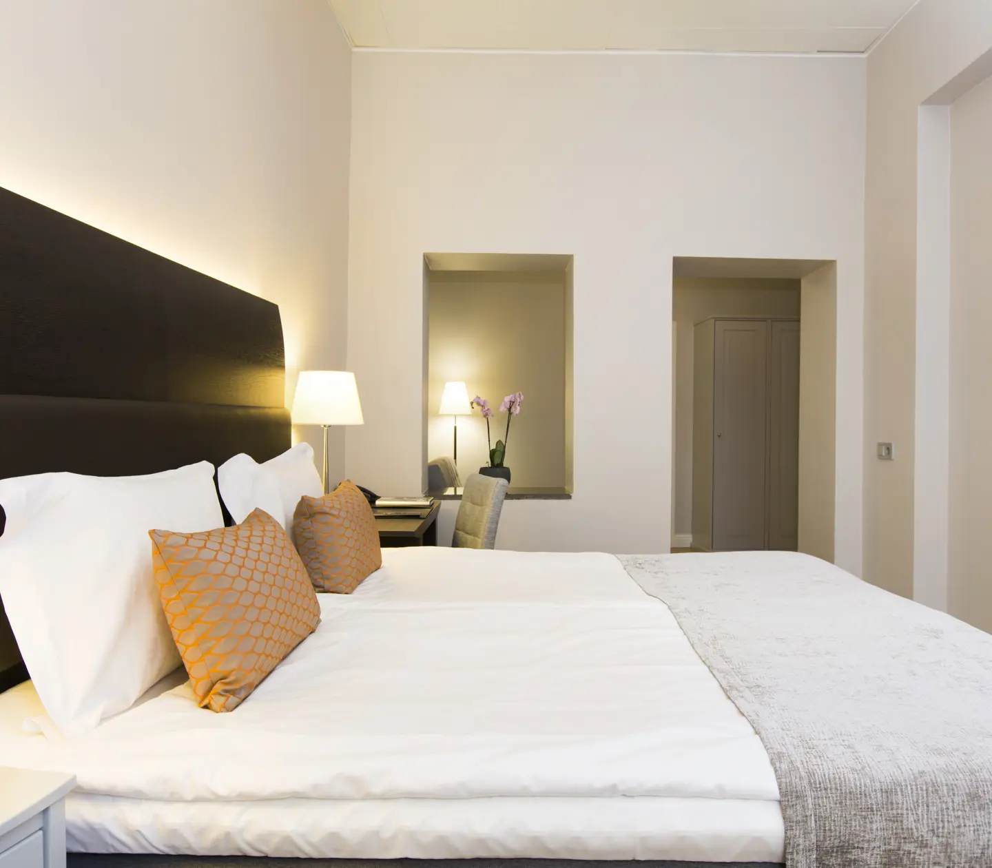 Room with beautifully made double bed
