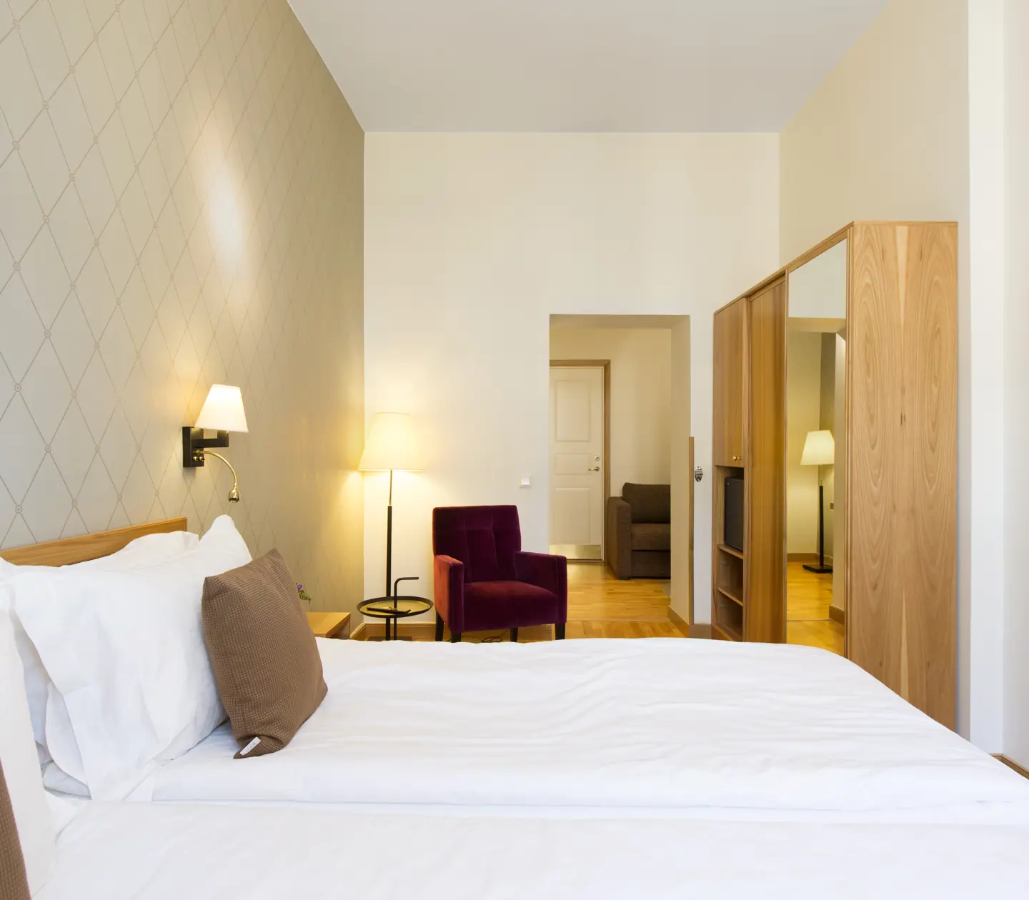 Room with double bed and armchair