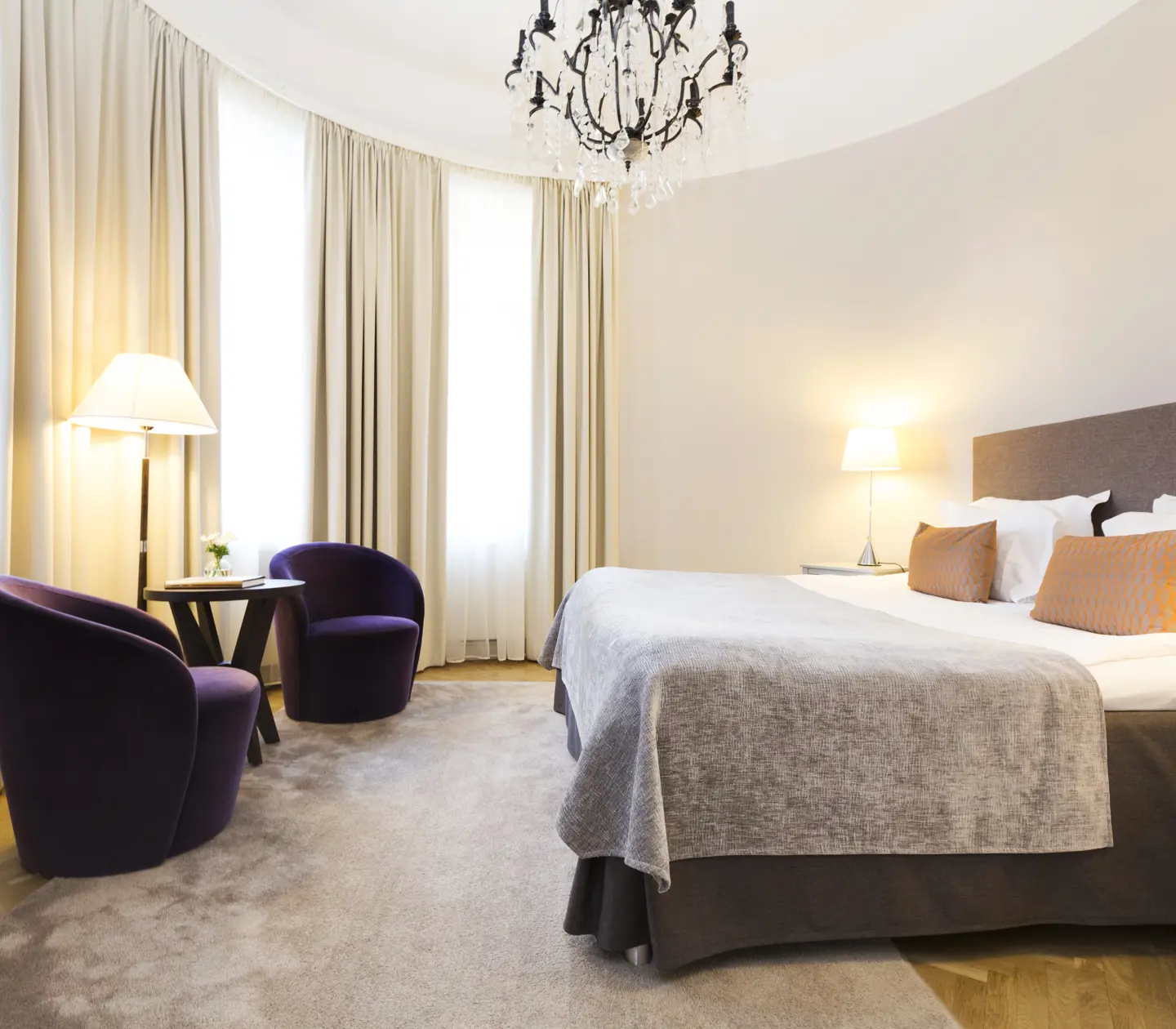 Beautifully decorated room with double bed and seating area