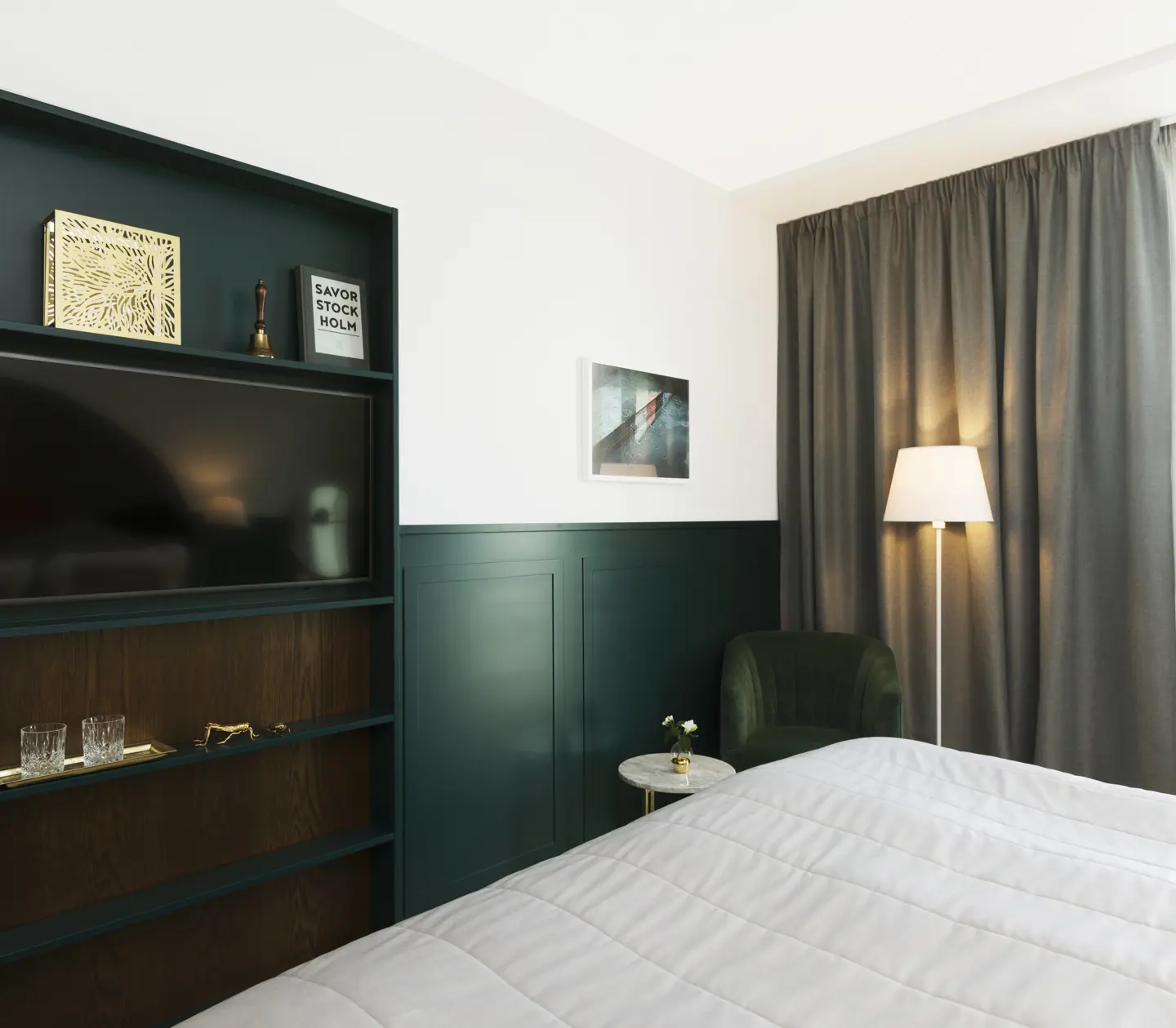 Bright hotel room with bookshelf, armchair and ceiling lamp