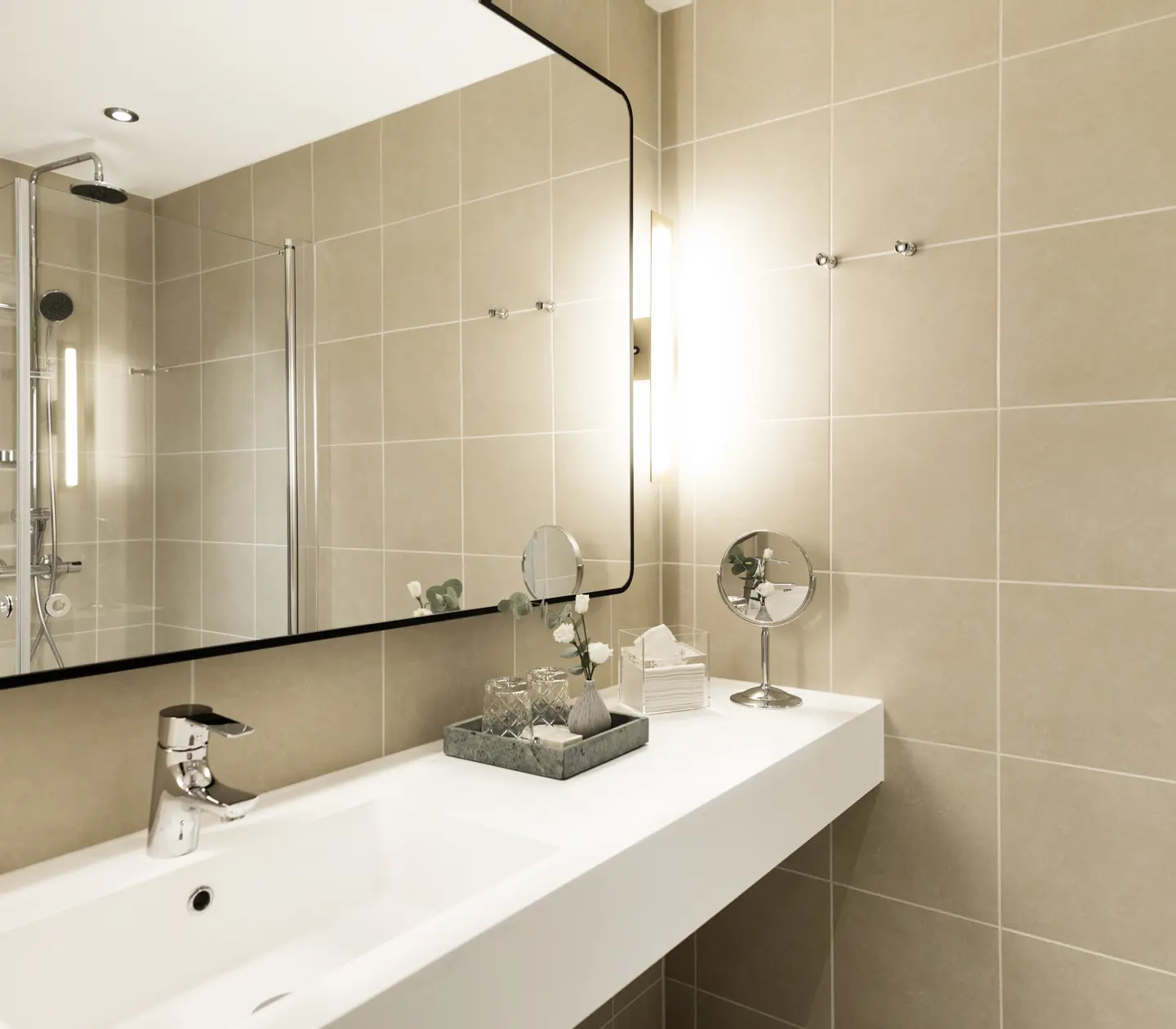 Beige bathroom with shower, sink and mirror