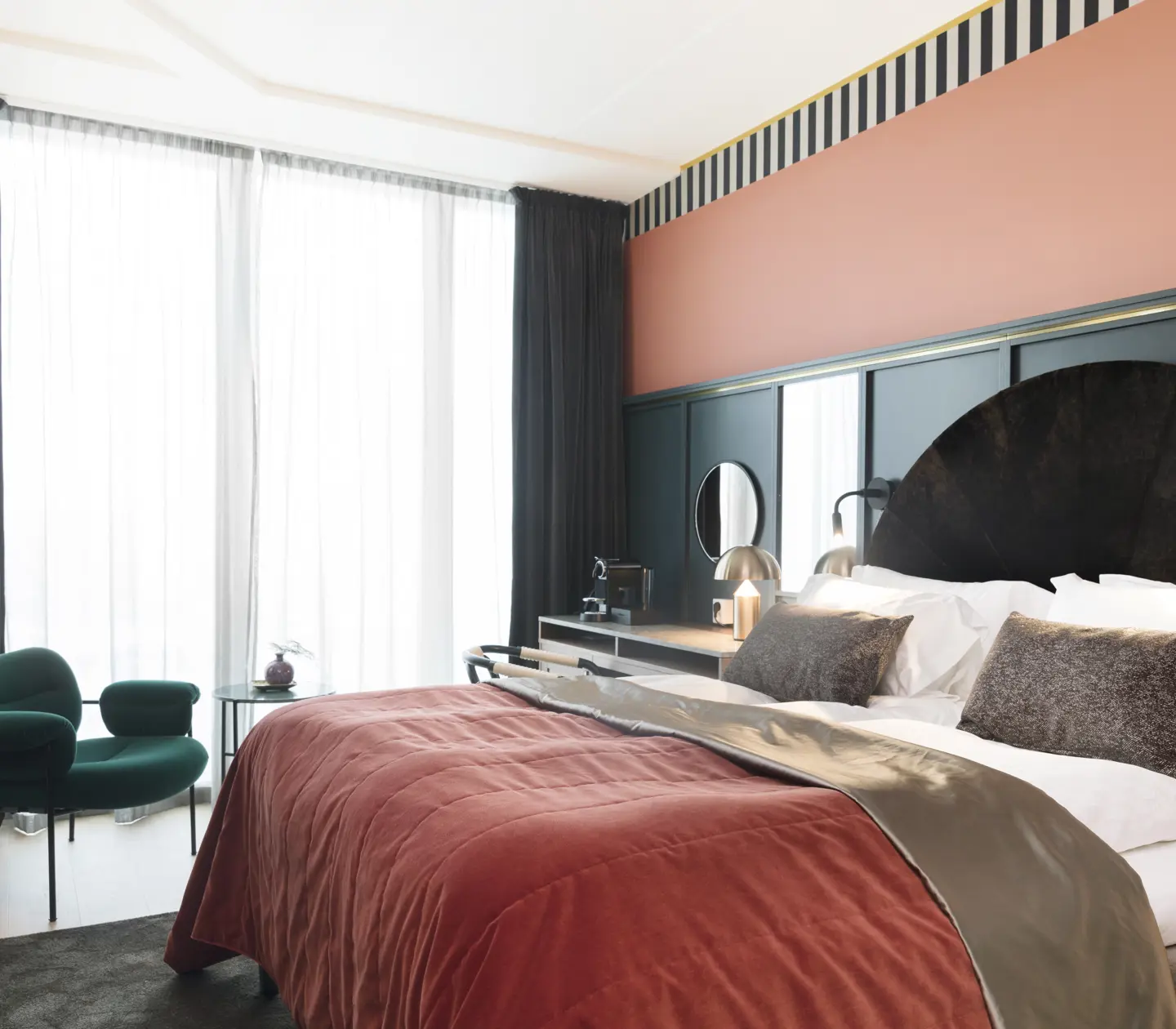 Cozy hotel room with bed, desk and large window