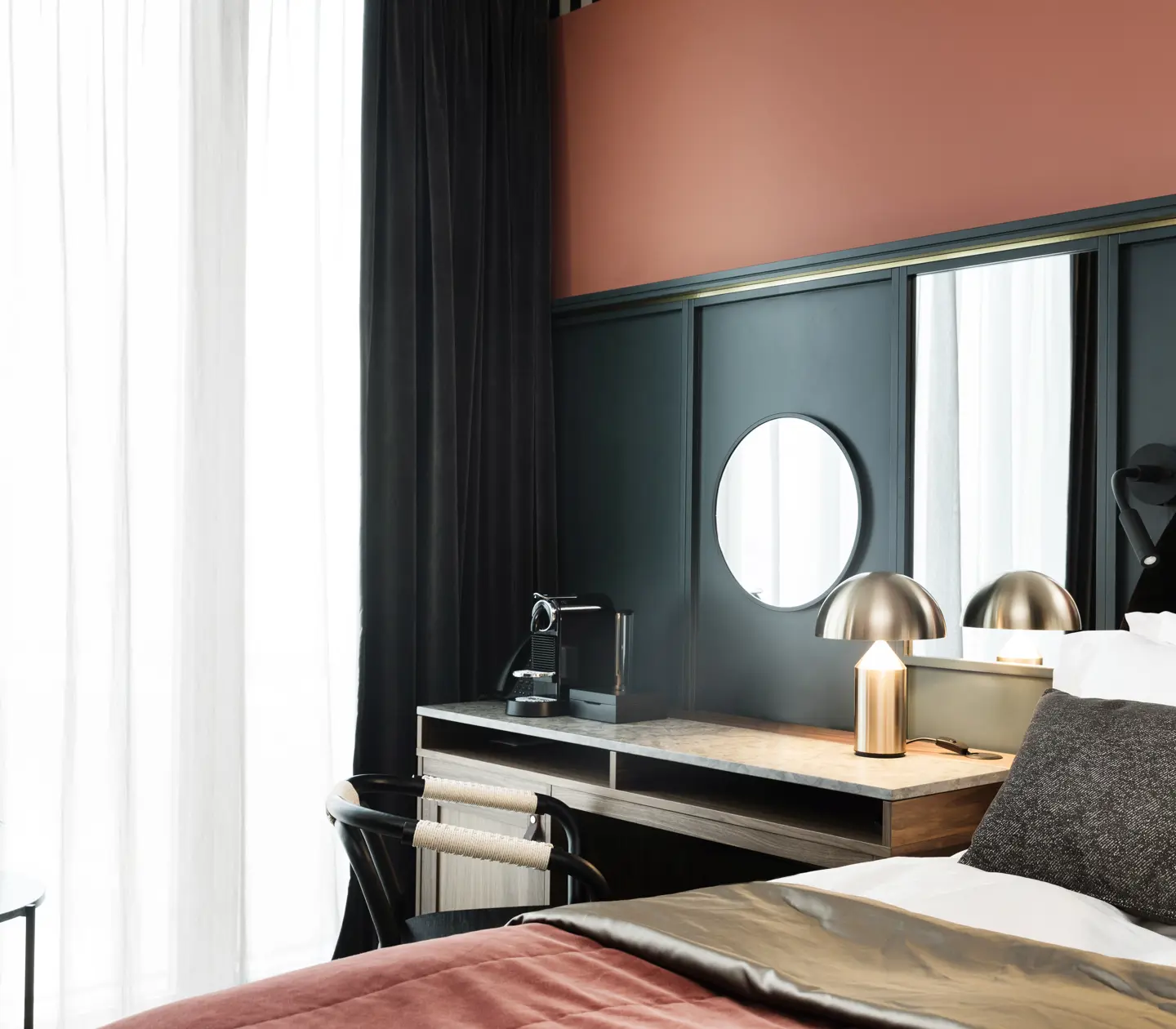Cozy hotel room with bed, desk, blue and red wall