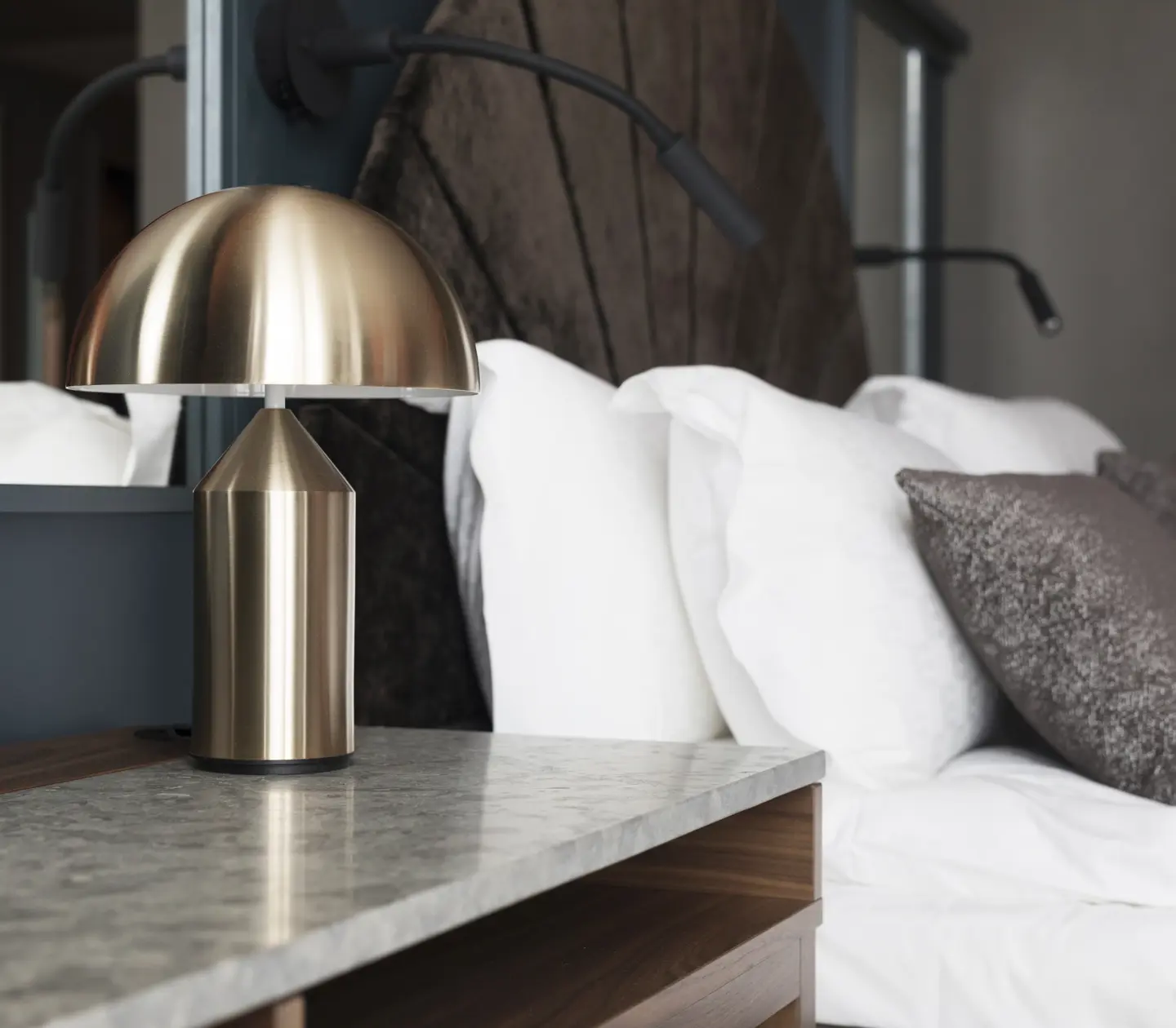 Cozy hotel room with bed, mirror and bedside lamps