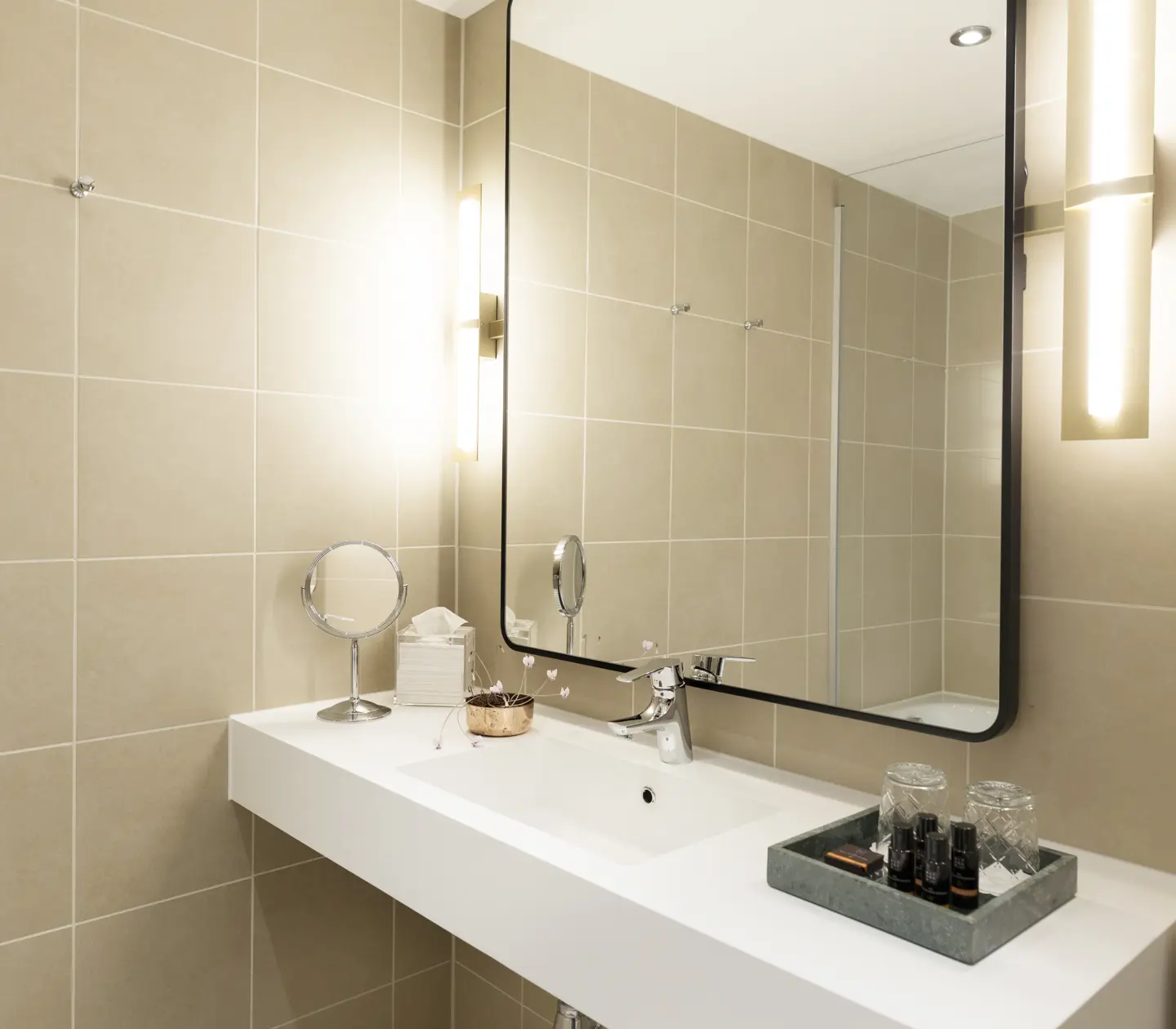 Beige bathroom with sink and mirror